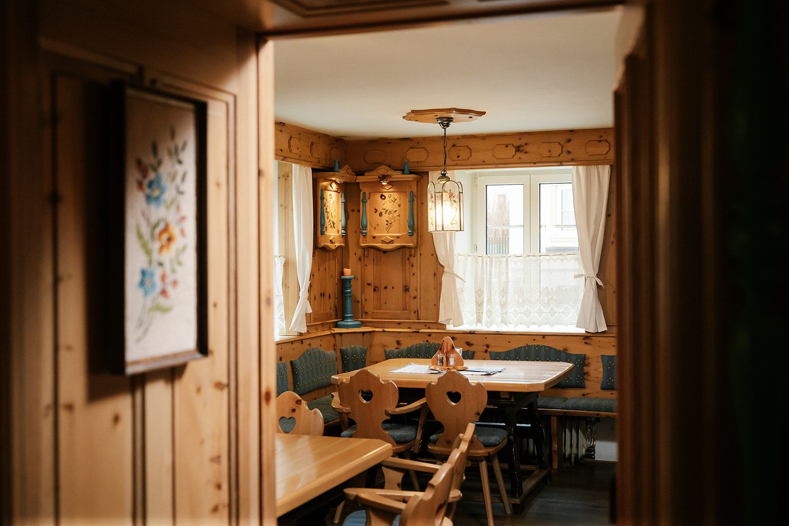 Cozy, rustic parlor with wooden furniture and decorative elements.