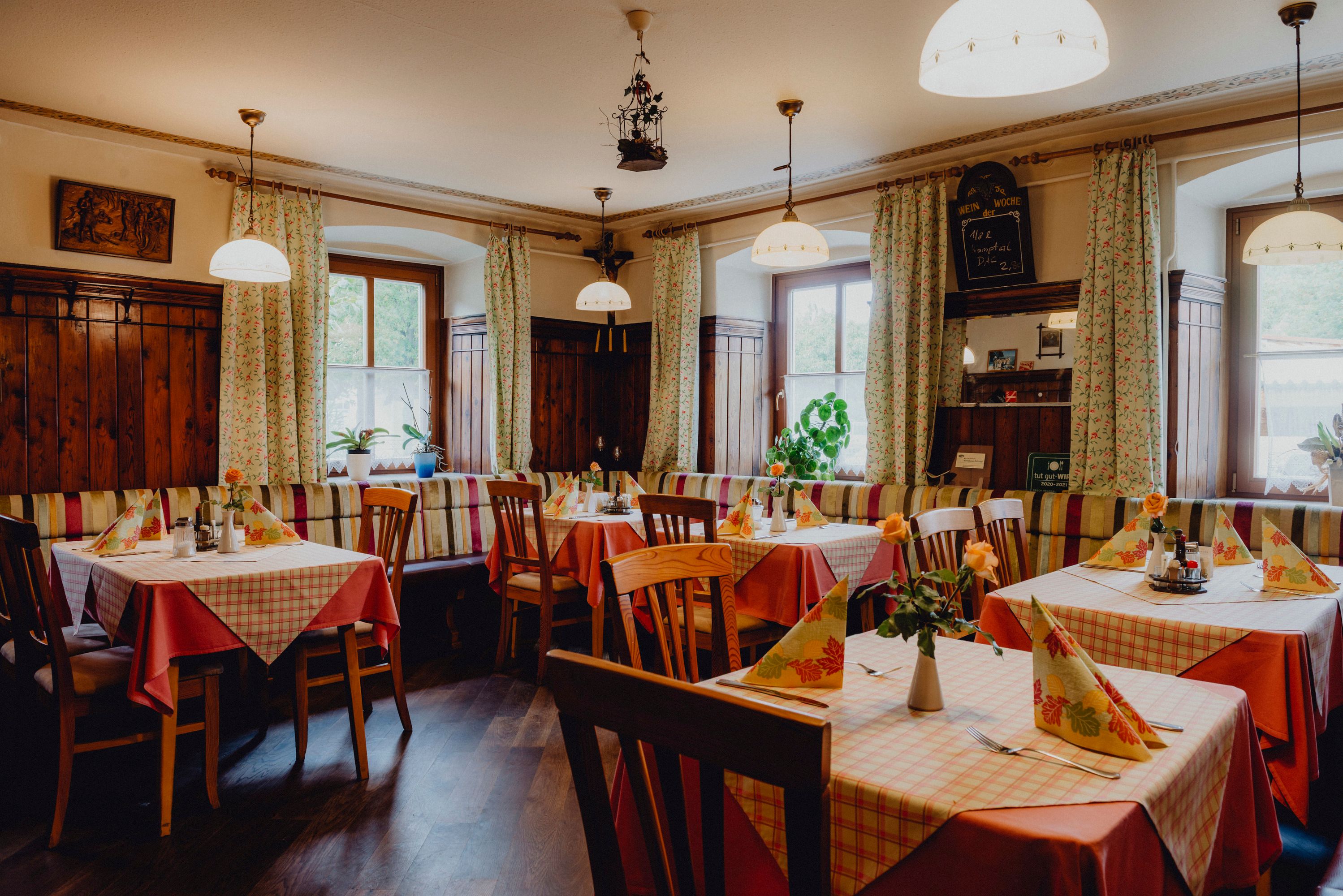 Cozy inn with wooden furniture and checkered tablecloths.