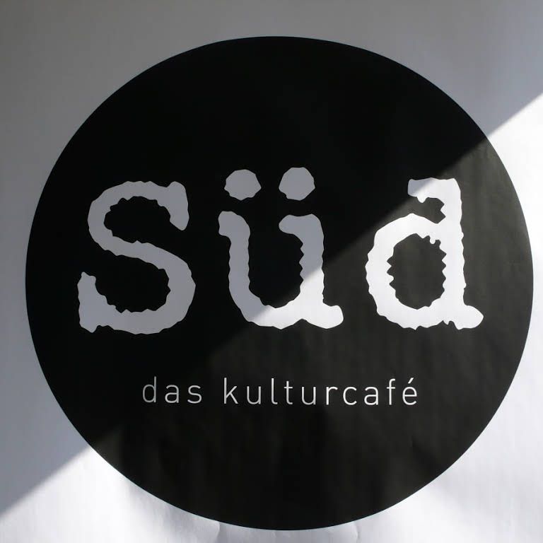Logo of the Kulturcafé Süd with white lettering on a black circle.