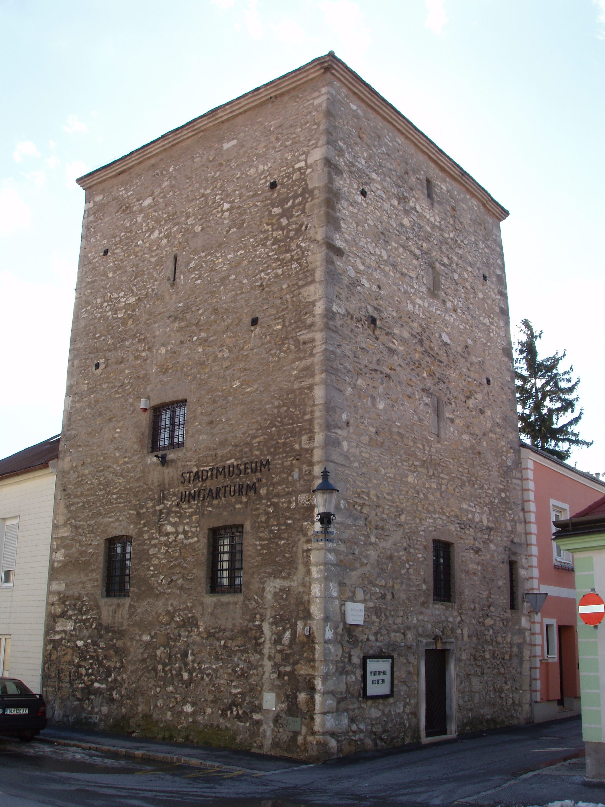 The Ungarturm in Bruck an der Leitha, a historic stone building with small windows, houses the town museum.