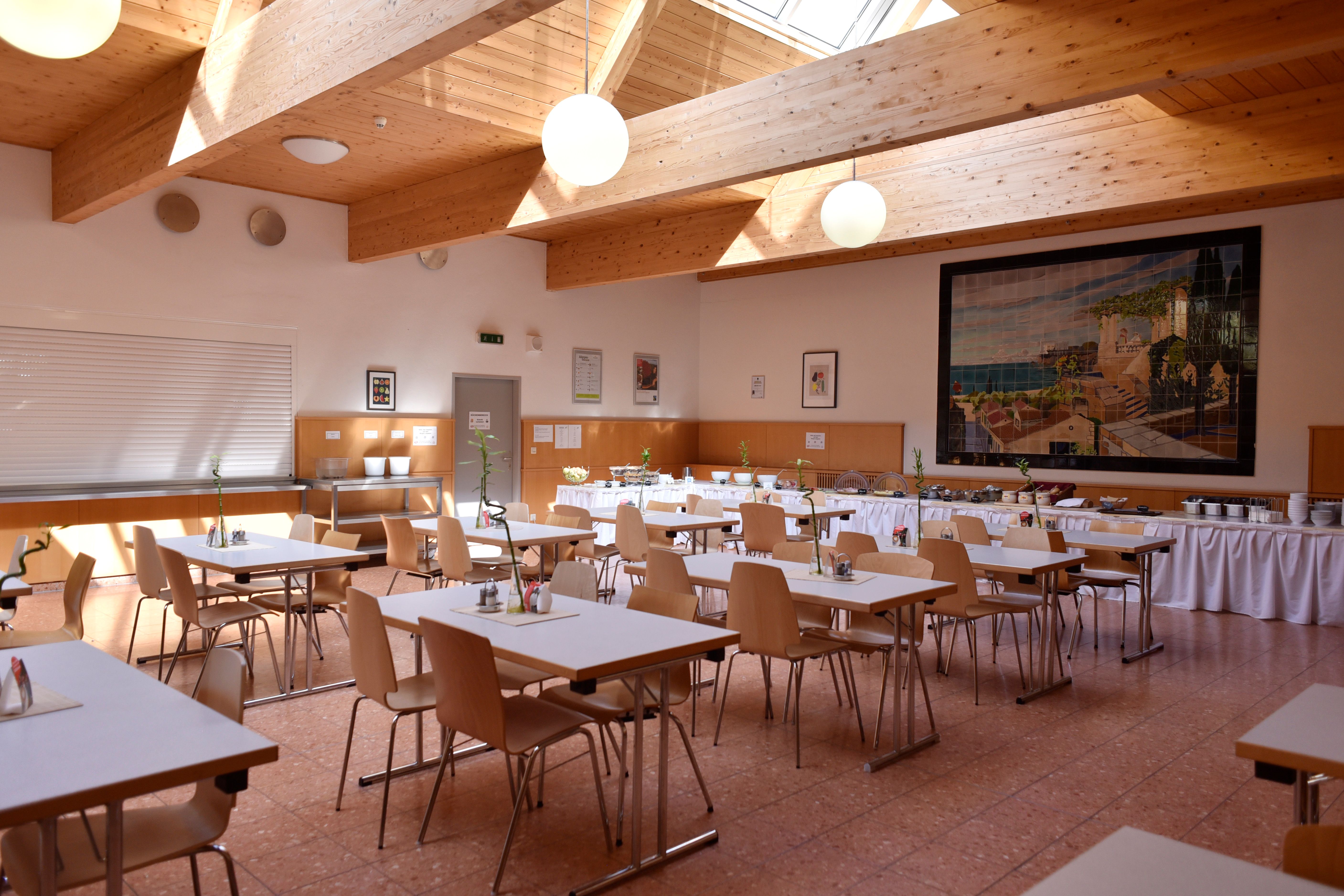 Breakfast room laid out with tables for a group 