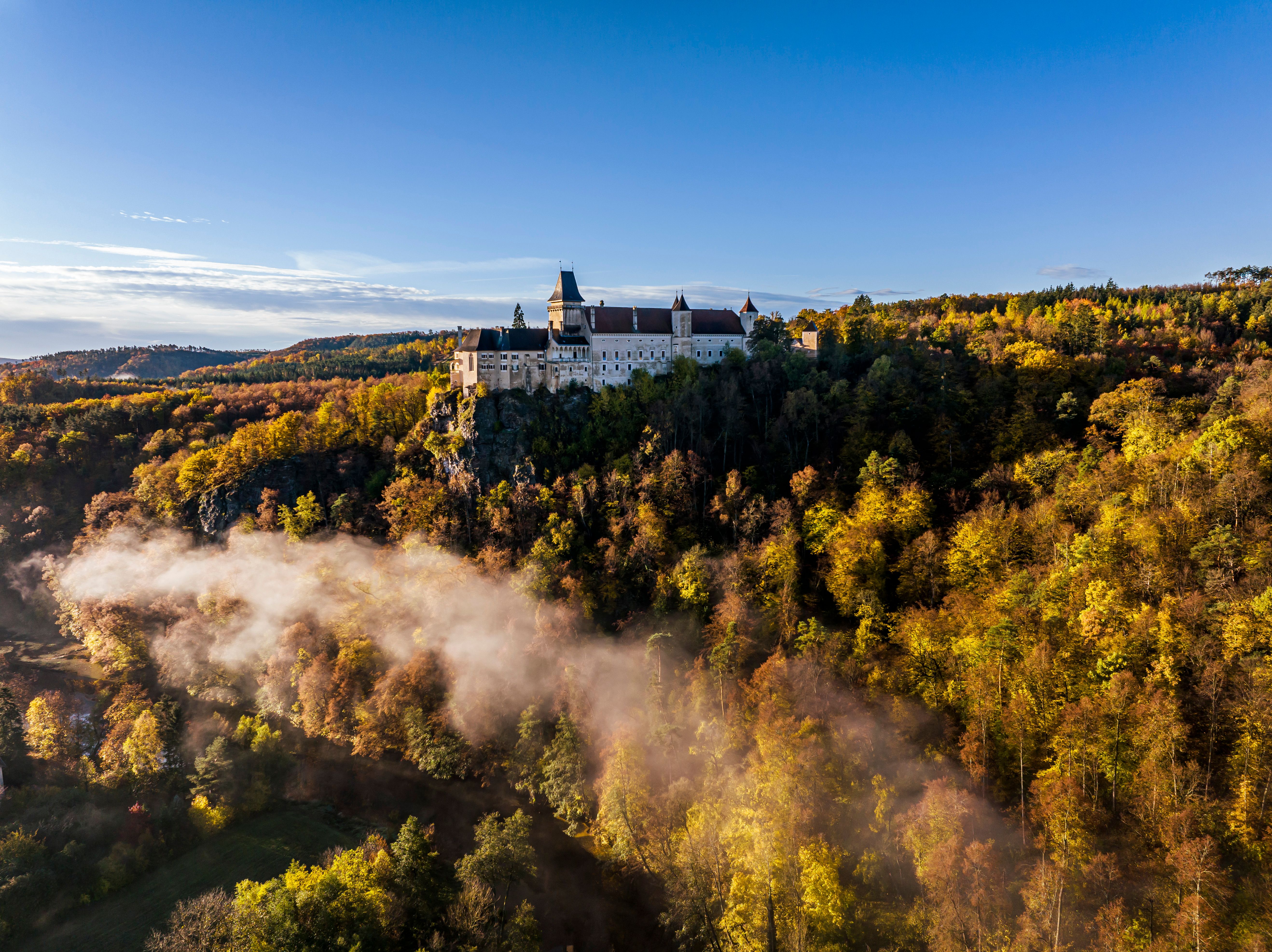 Aerial view of the Rosenburg surrounded by green forests and hills.