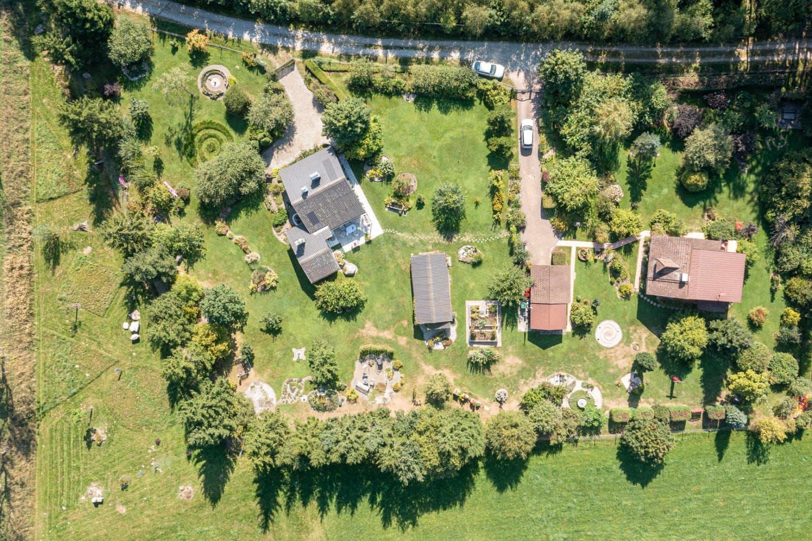 Aerial view of a garden with several buildings and trees.