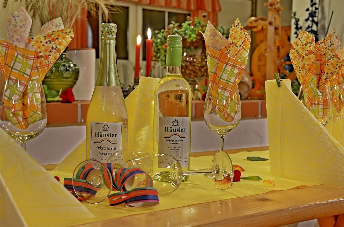 Festively laid table with wine bottles and glasses.