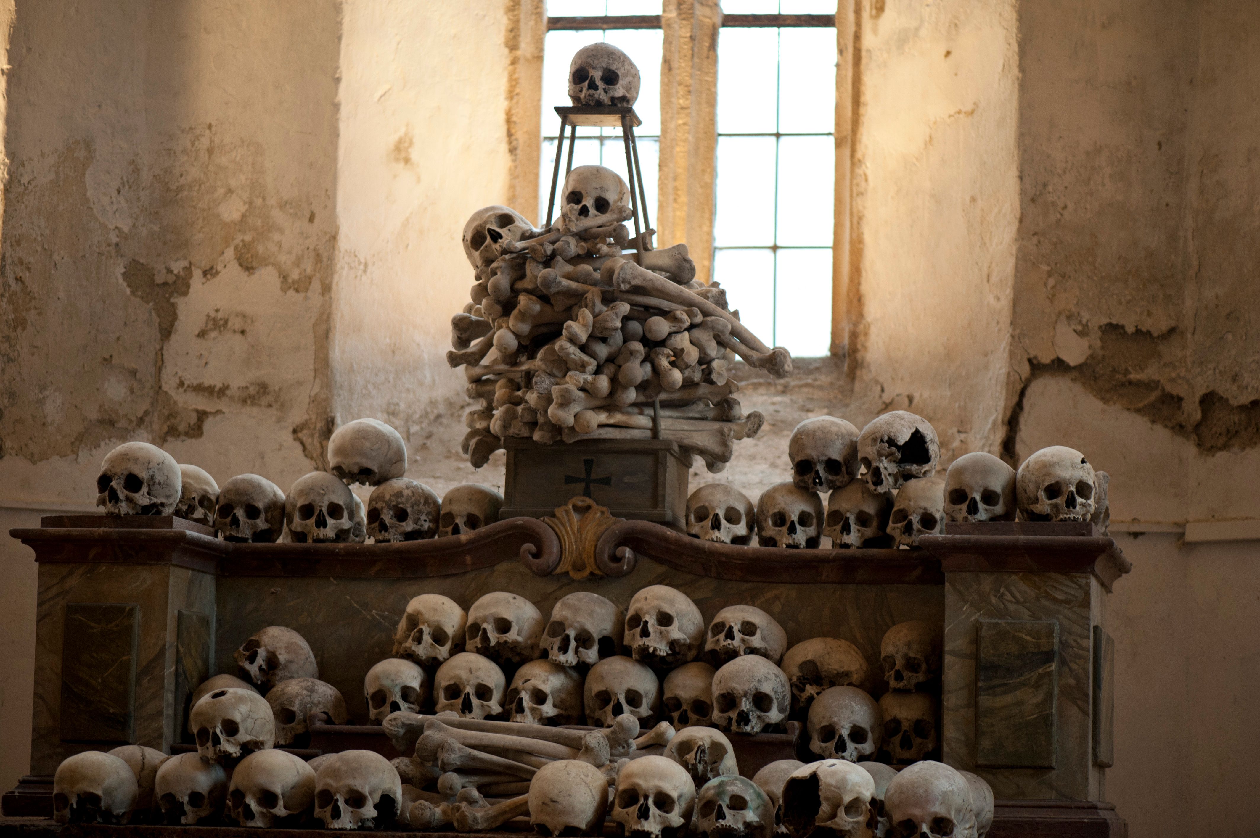 Many skulls stacked in a church