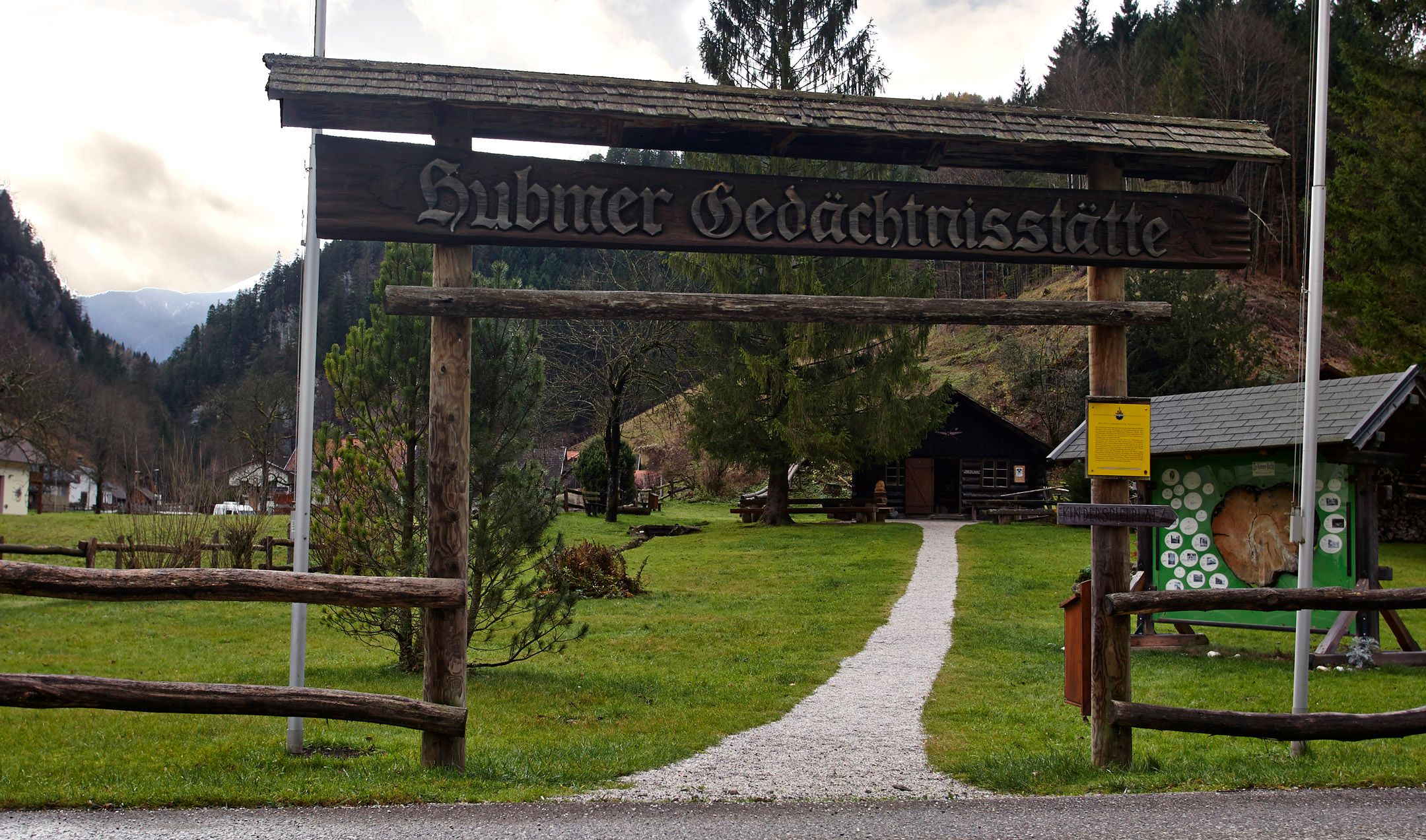 Entrance to the Hubmer memorial with wooden gate and path.