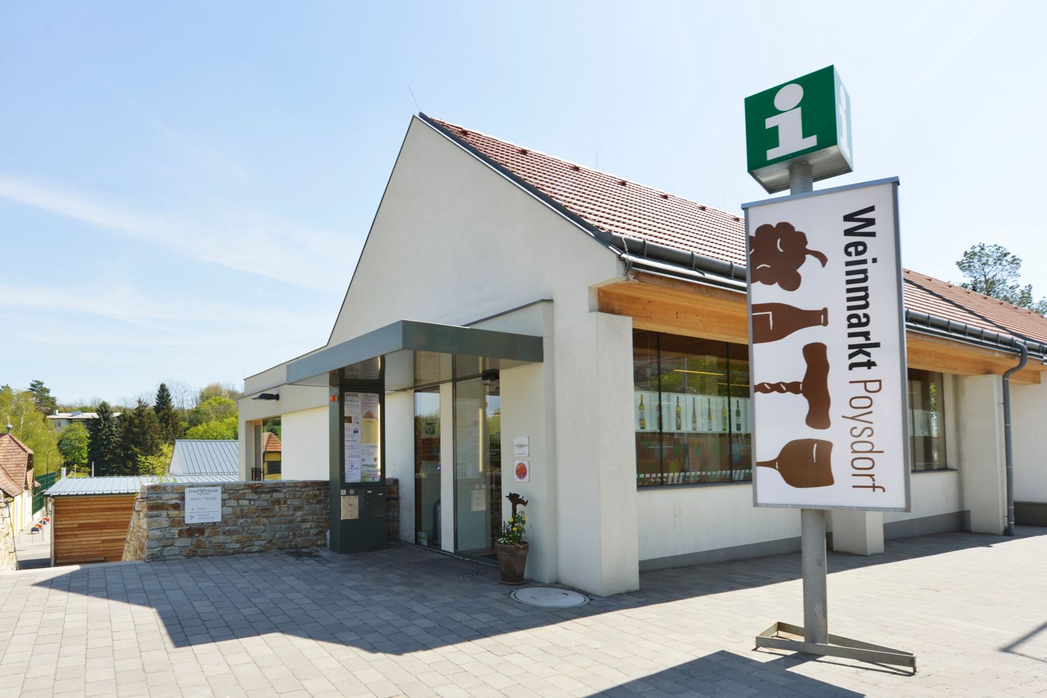 Entrance to the Poysdorf wine market with sign and glass façade.