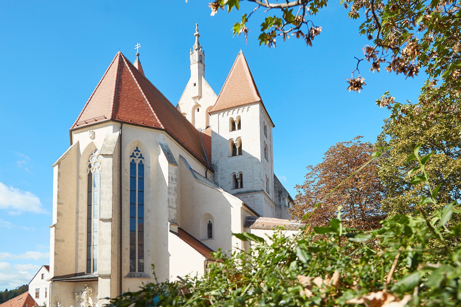 Church in Eggenburg with red roofs and blue sky.