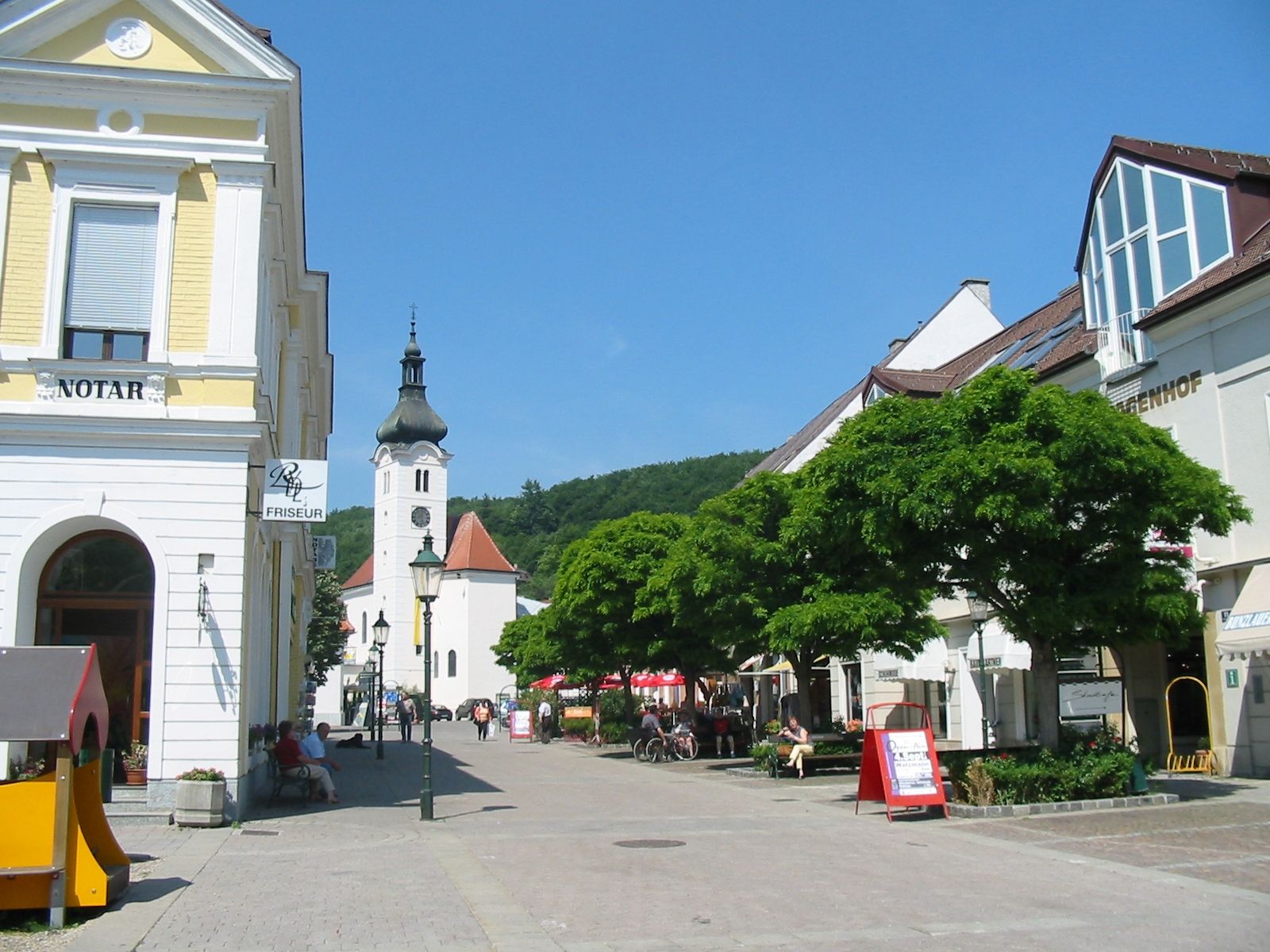 Main square in Purkersdorf with church and stores.