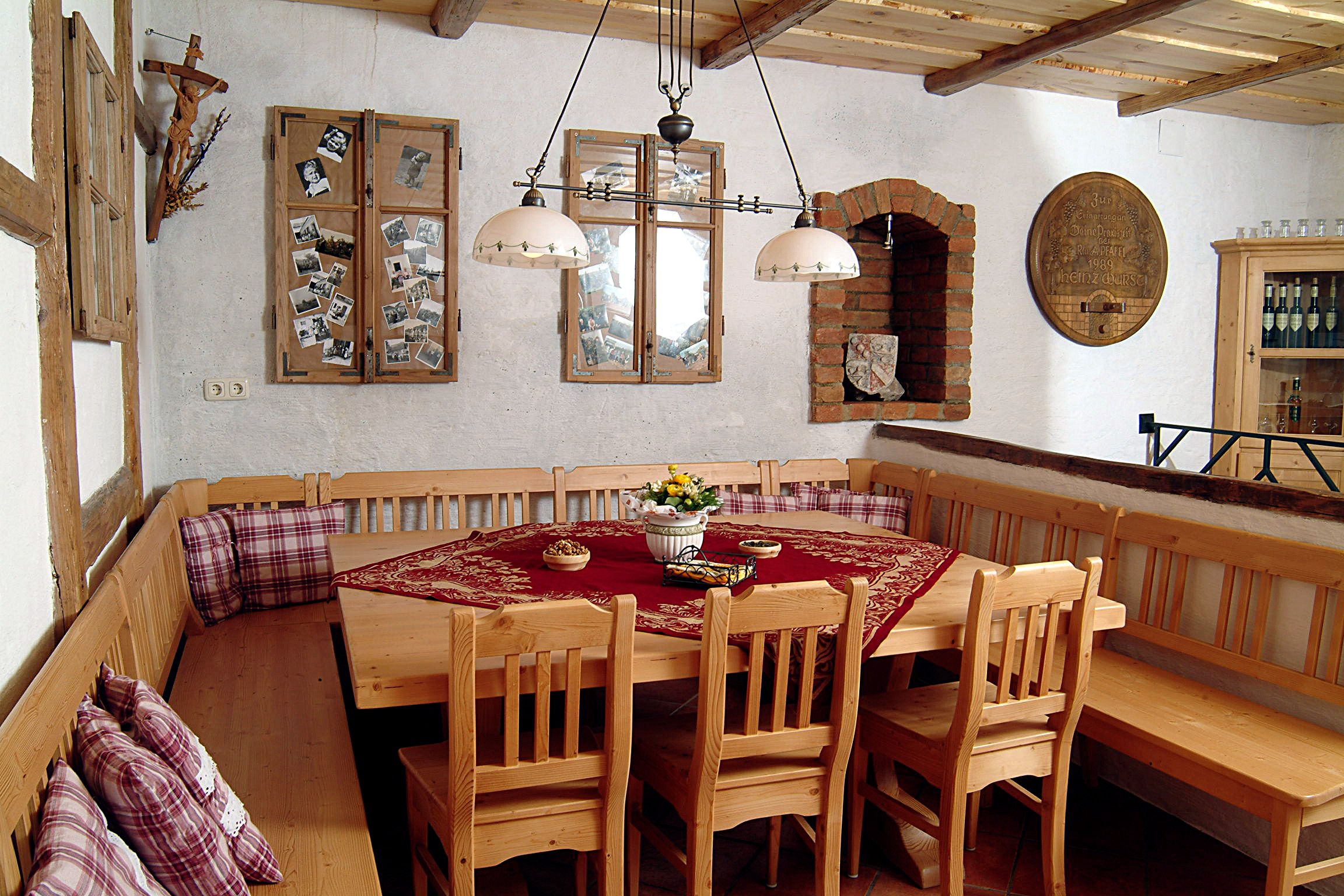 Cozy tasting room with wooden furniture, tablecloth and decorations on the walls.