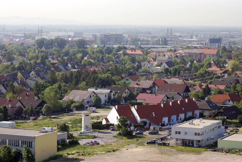Aerial view of Wiener Neudorf with residential and industrial buildings in the background.