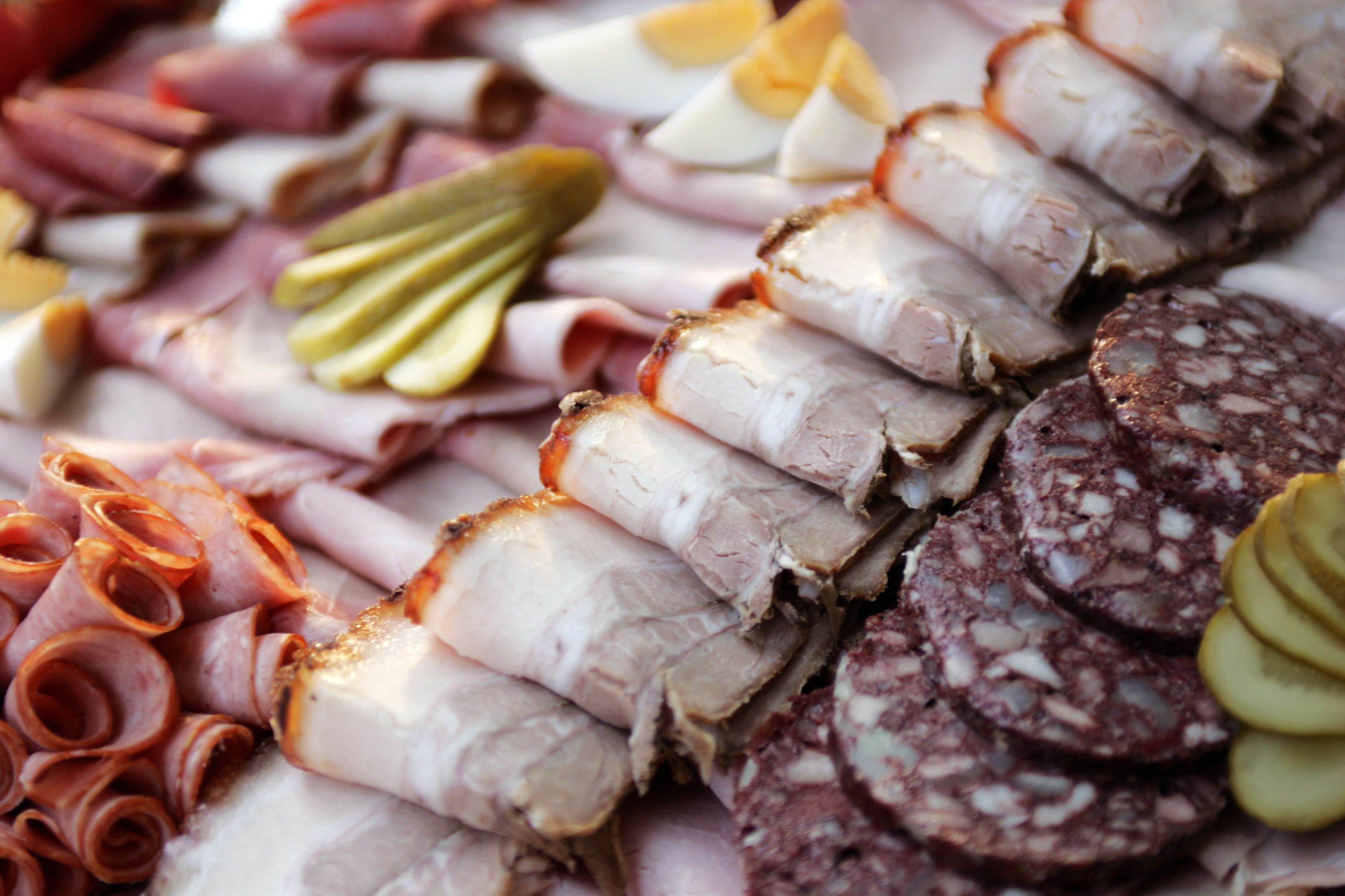 Various types of sausage and meat served on a plate.