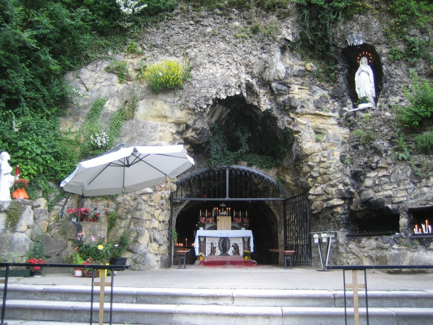 Lourdes grotto in the Vienna Woods with altar and statue of the Virgin Mary.