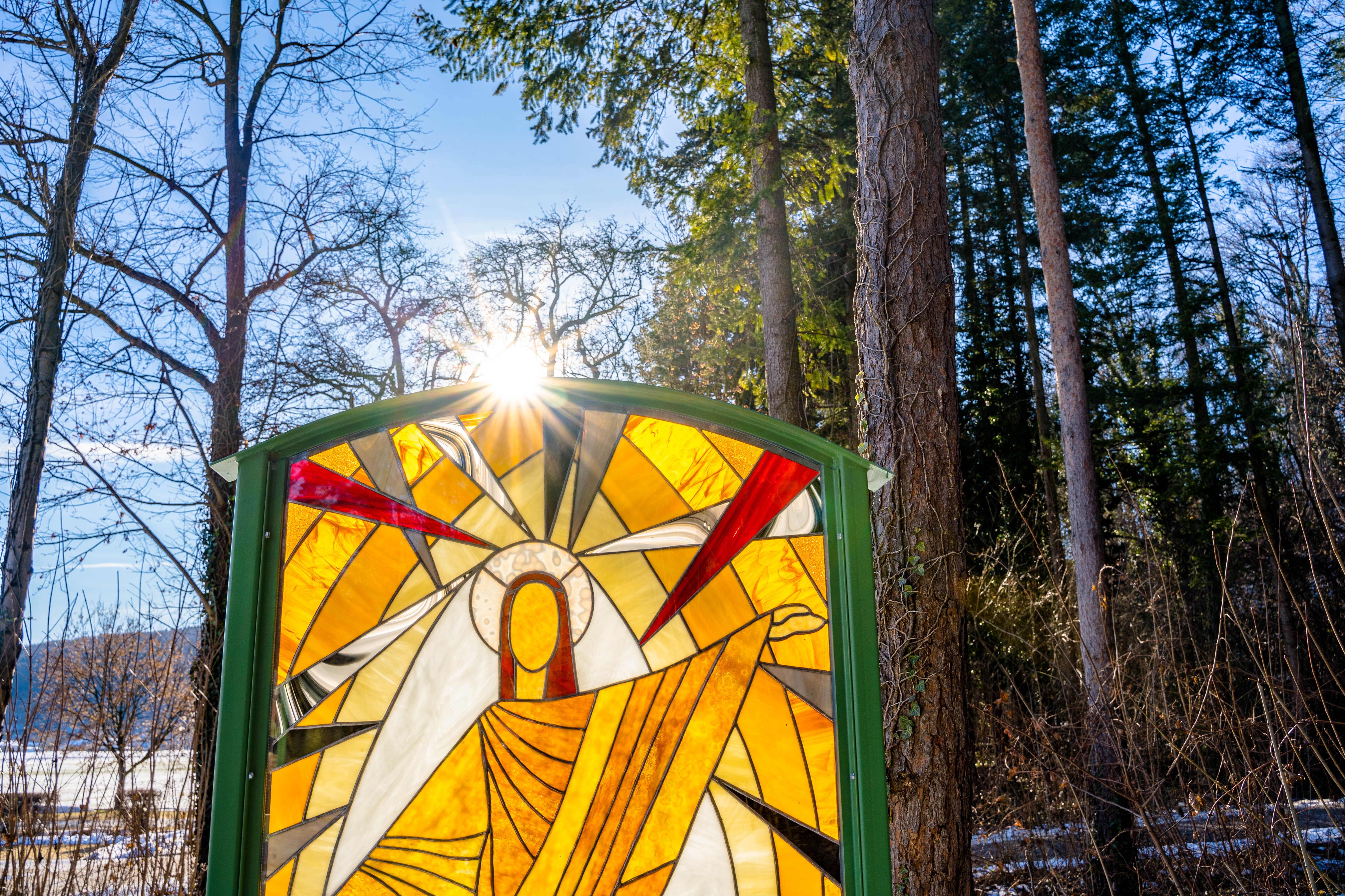 Stained glass window illuminated by the sun in the forest