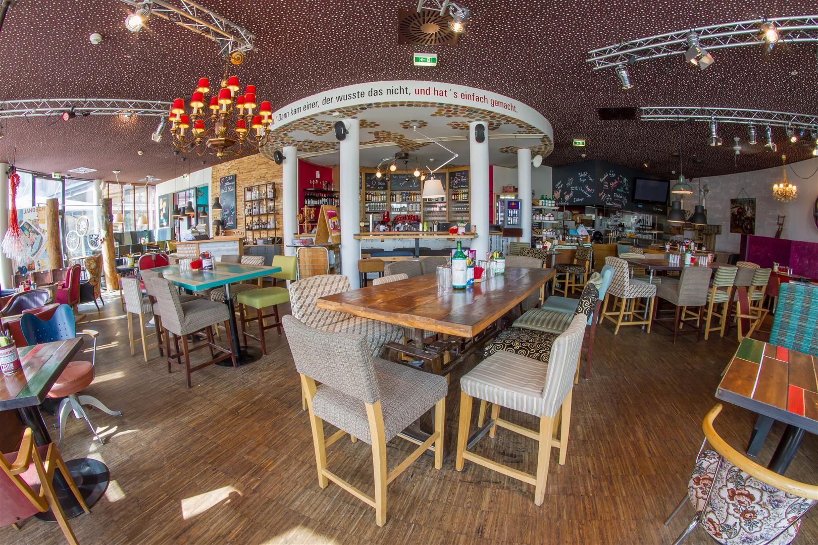 Interior of a stylish café with wooden furniture and decorative elements.