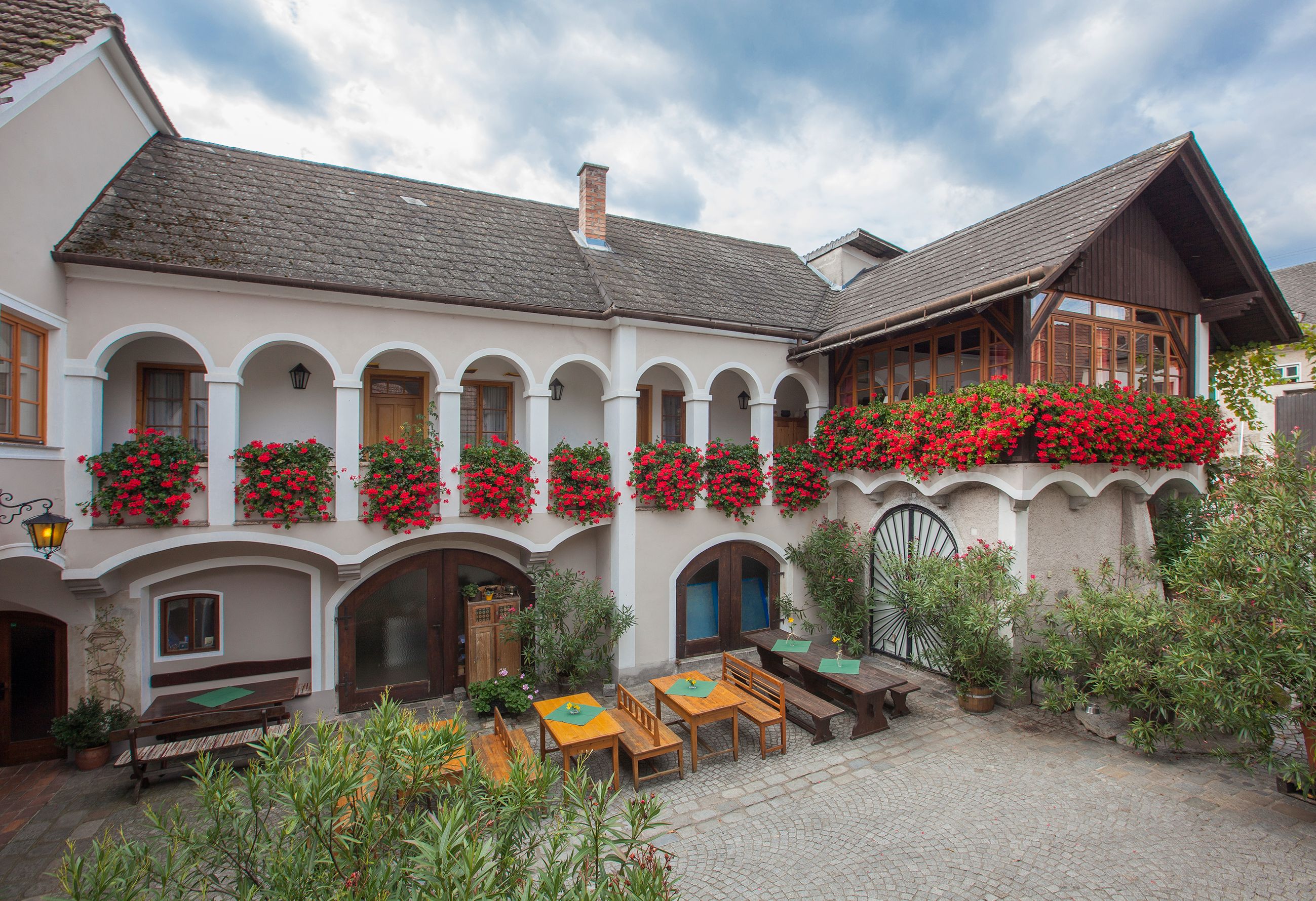 Traditional building with arcades and flower boxes.