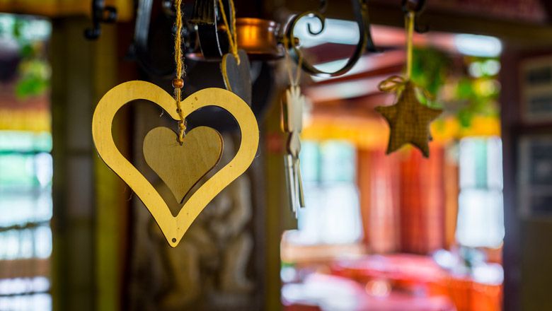 Wooden heart and star as decoration in a cozy hut.