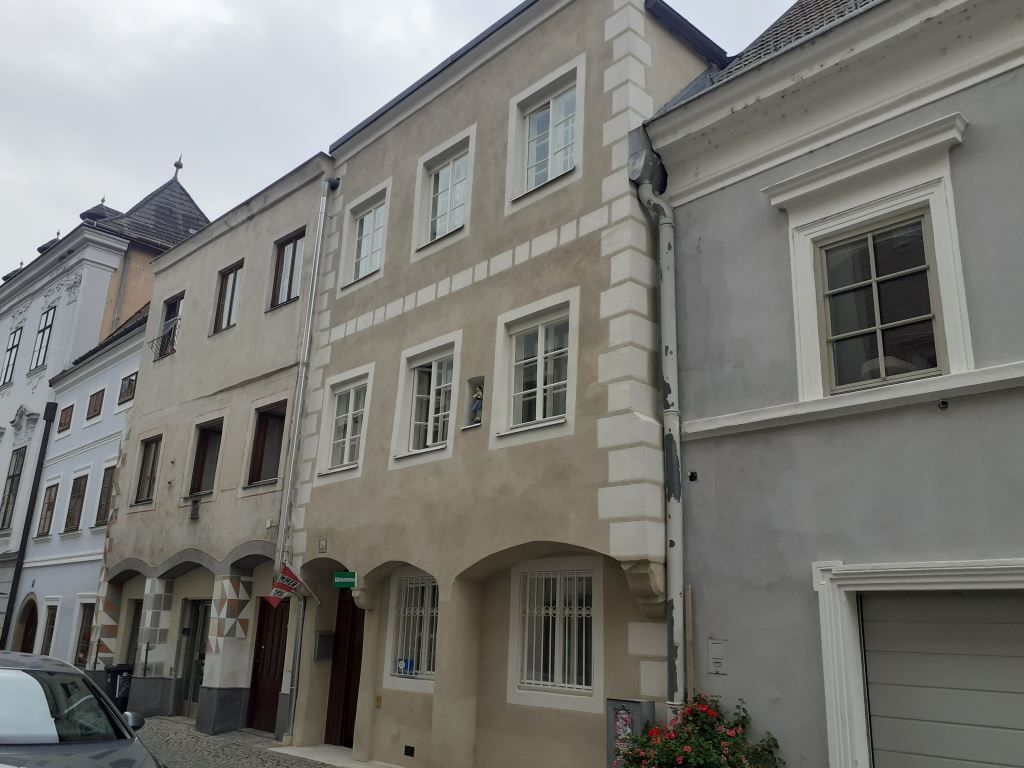 Terraced houses in a European town with a paved street.