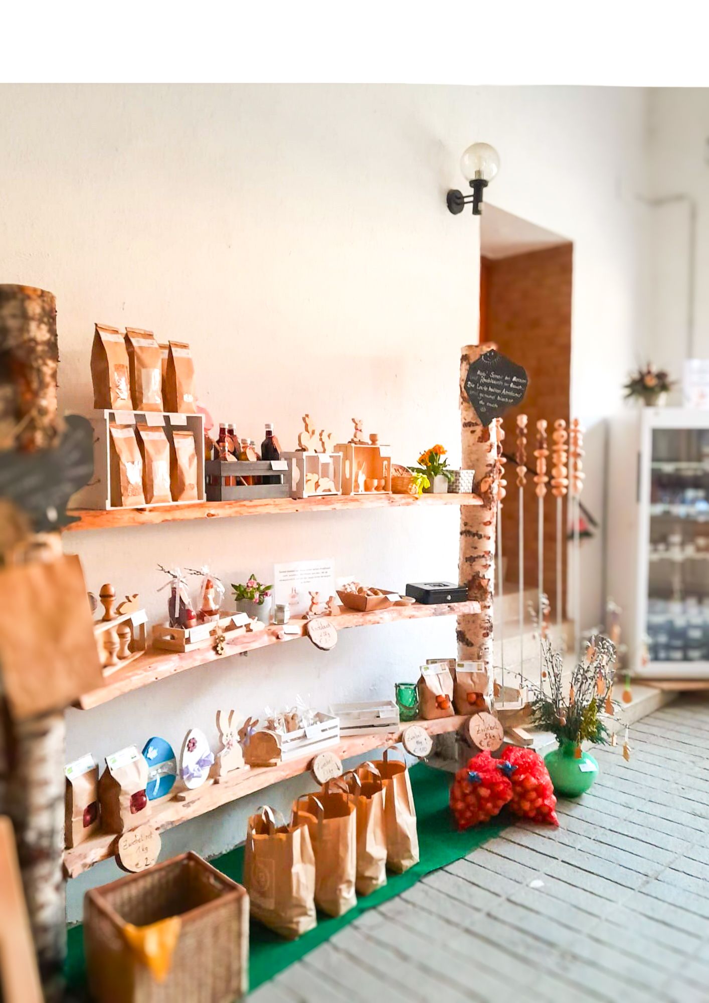 A shelf with various handmade products and food in a small store.