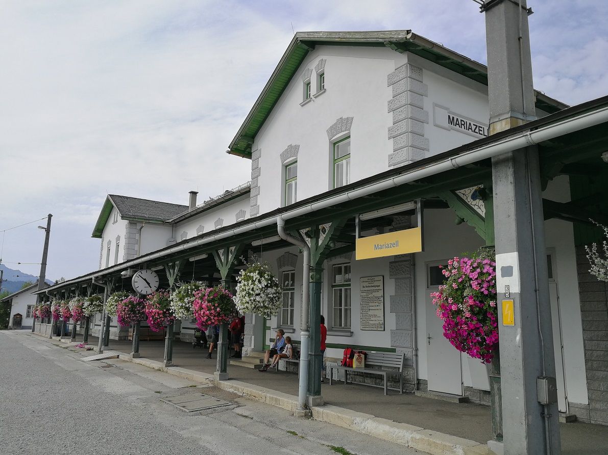 Mariazell station with flowers and clock.