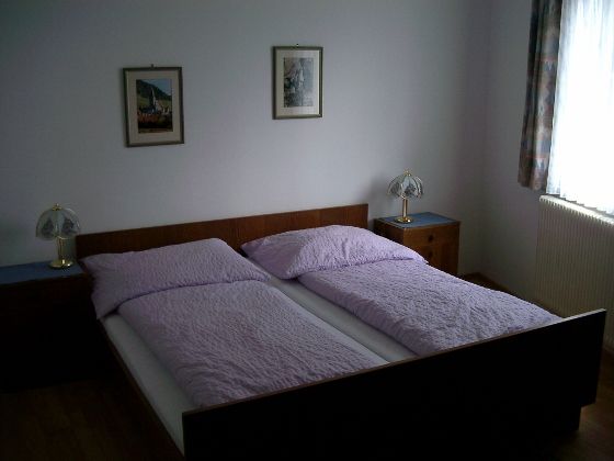 One bedroom with a double bed, two bedside tables and two table lamps.