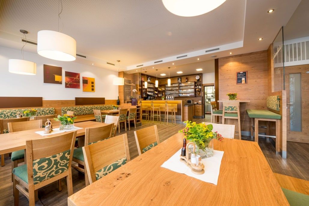 Interior view of a cozy inn with wooden furniture and bar.