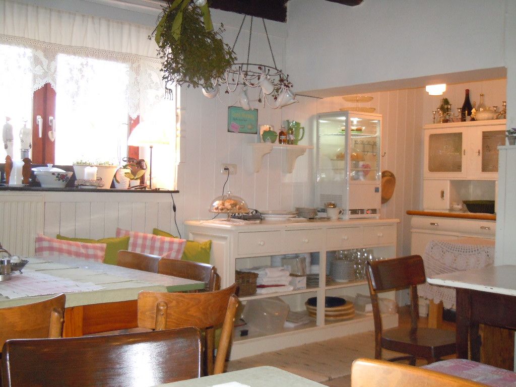Cozy kitchen with breakfast buffet, wooden furniture and decorations.