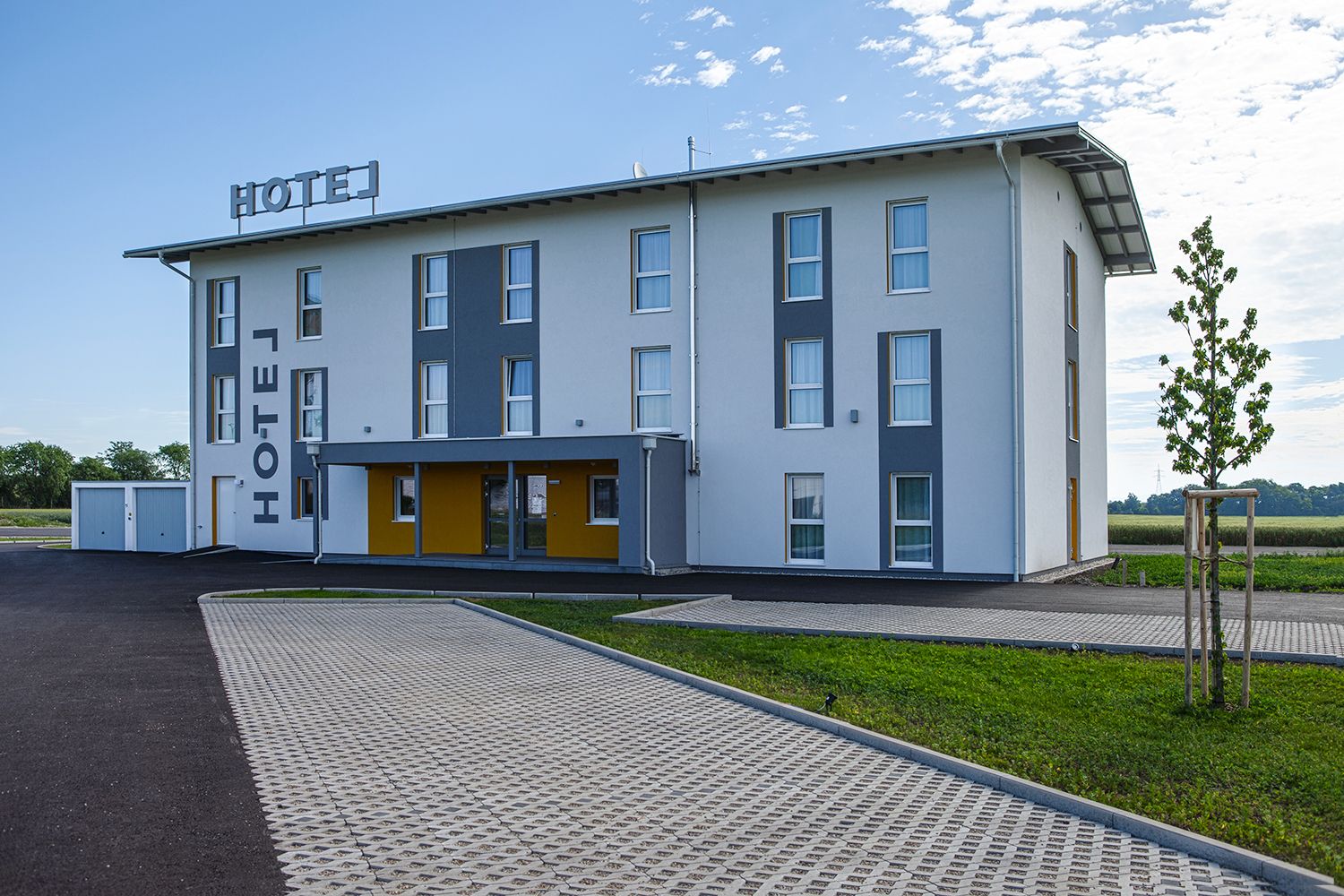 Exterior view of the hotel with the parking lot.
