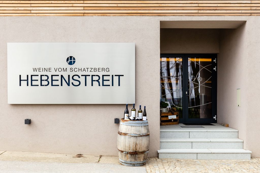 Entrance to Hebenstreit Weine with sign and wine barrel.