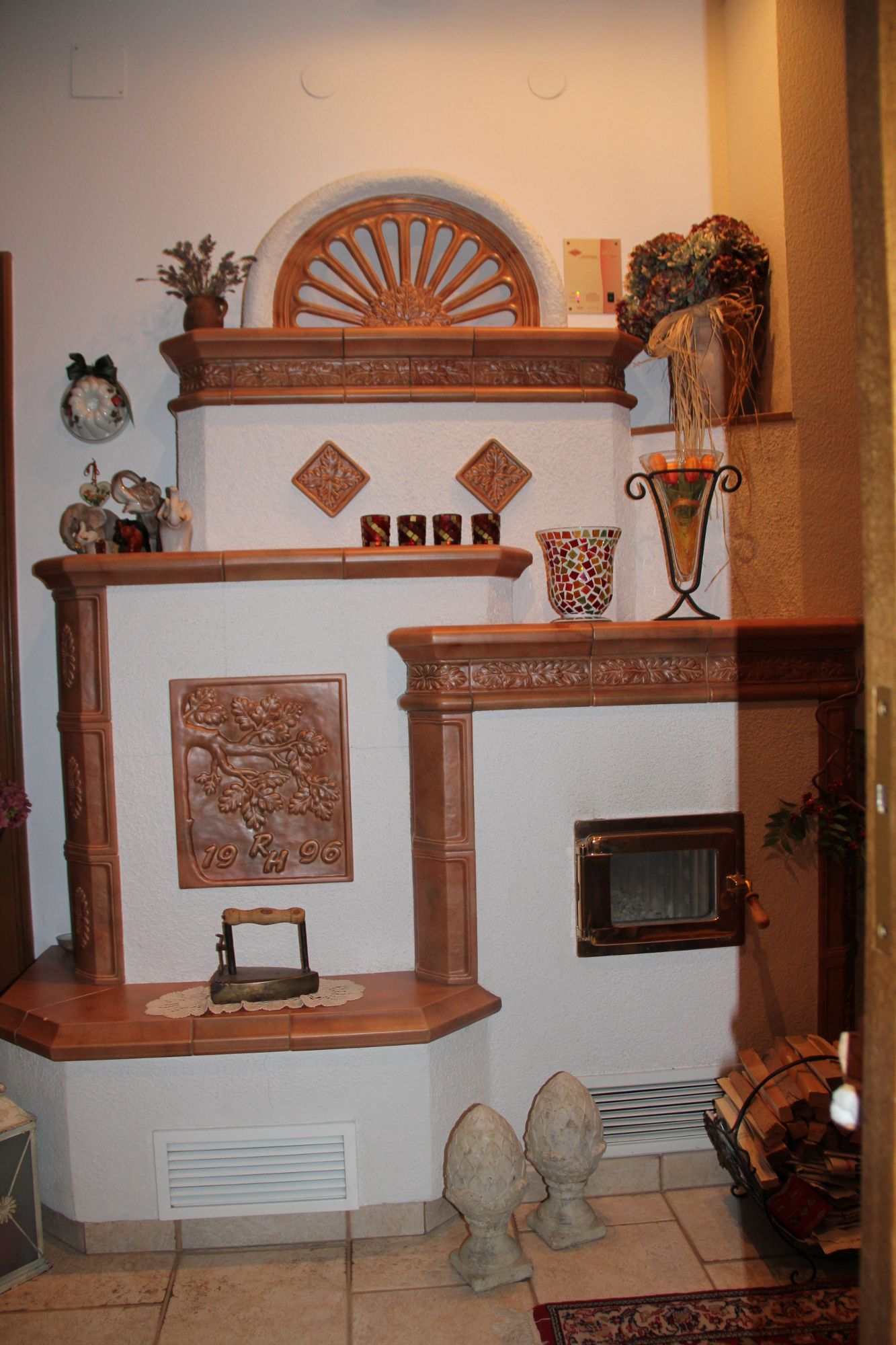 A decorative fireplace with ceramic ornaments and decorative objects.