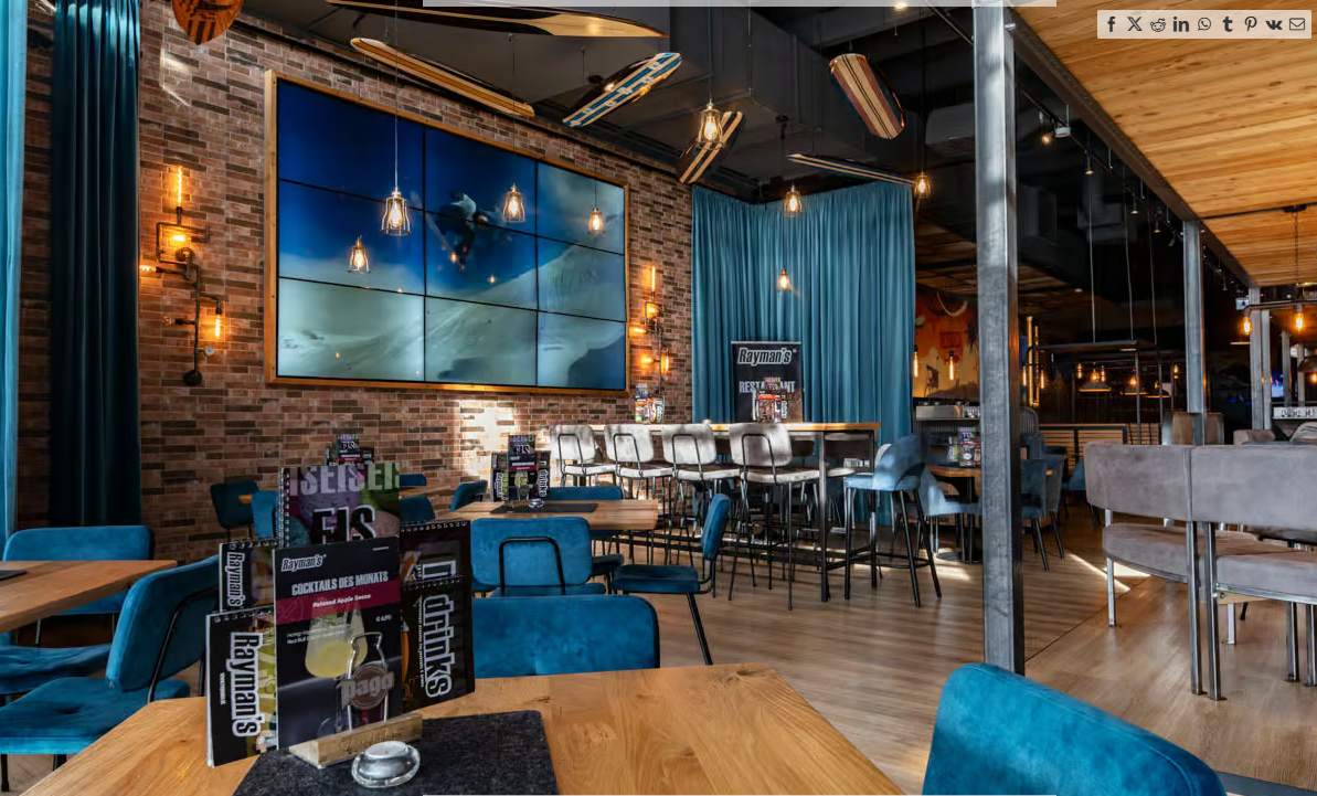 Restaurant furnishings with blue chairs, brick wall, curtains and atmospheric lighting