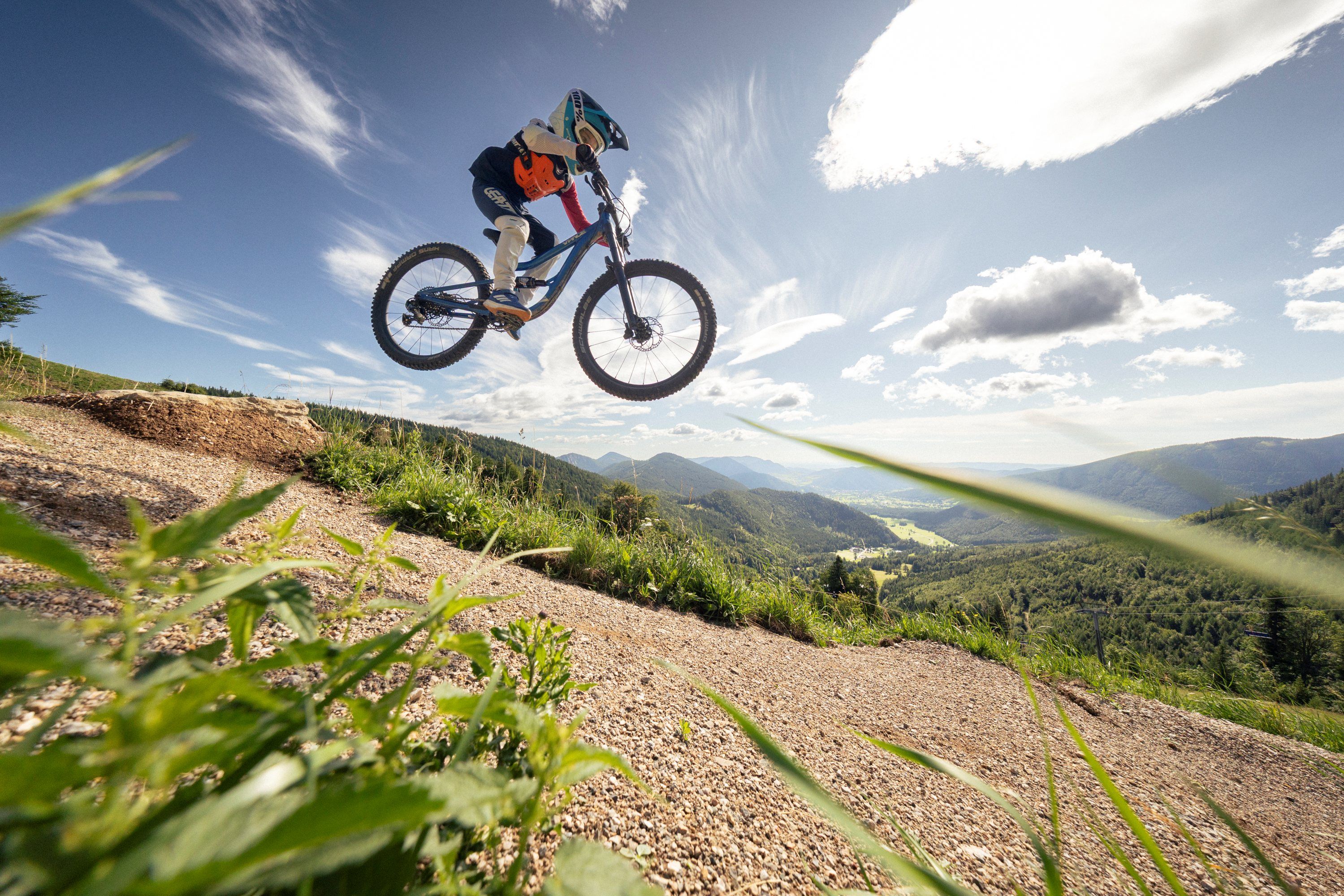 Biker jumps through the air on a mountain bike