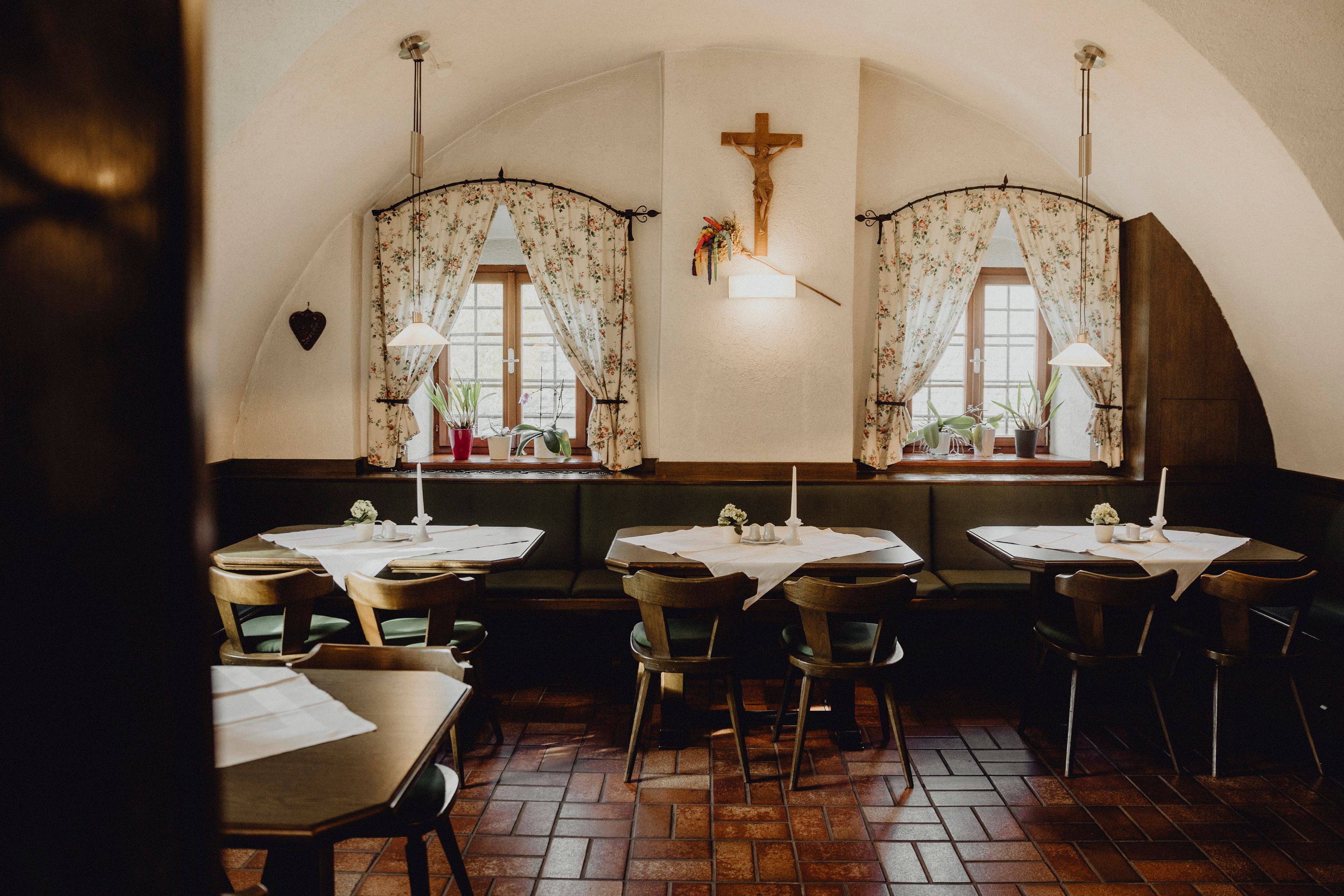 Cozy guest house with wooden furniture and decorative curtains.