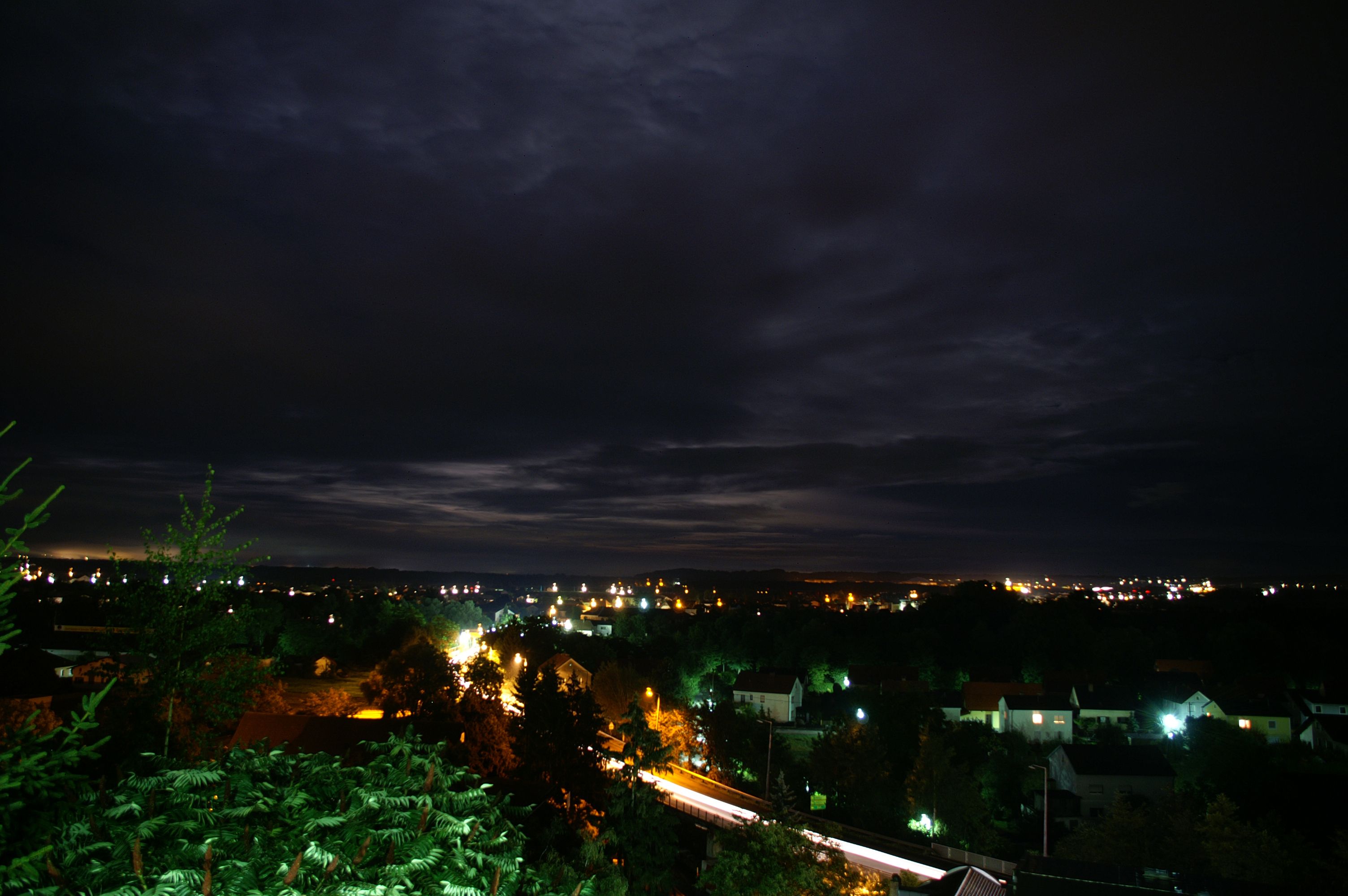 Night view of Ennsdorf with illuminated houses and dark sky.
