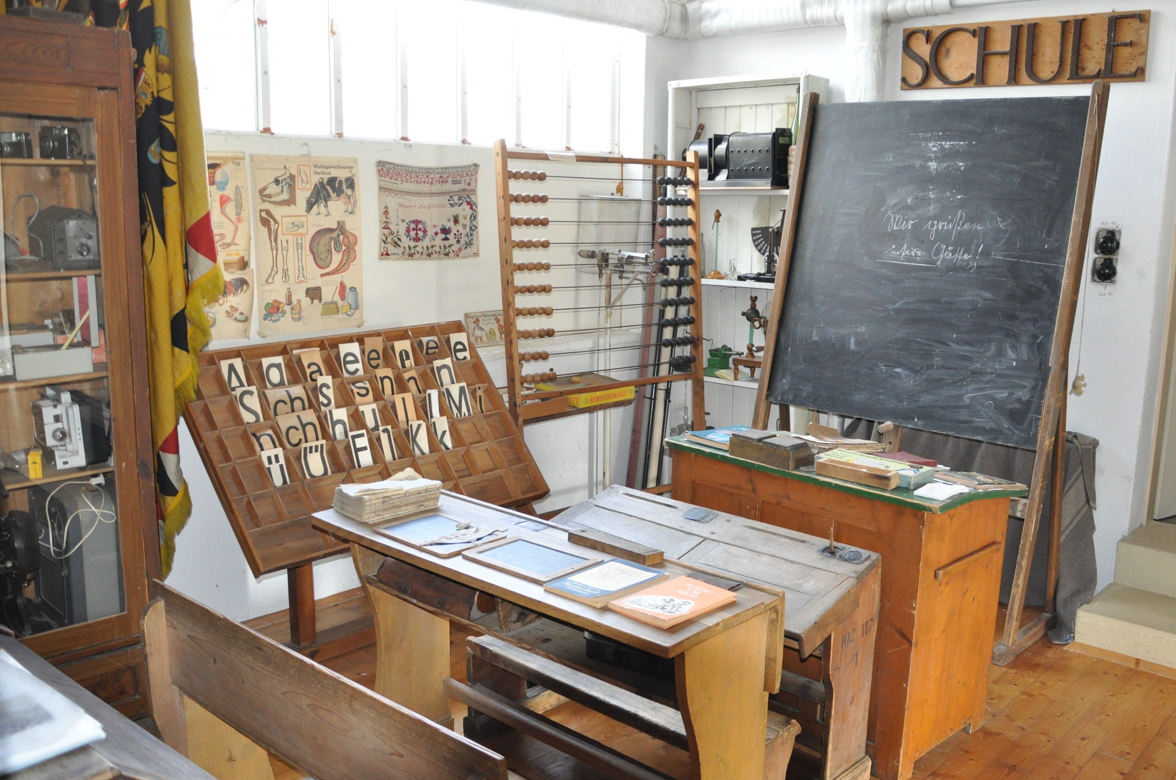 Historical classroom in the Michelhausen local history museum with blackboard, desk and teaching materials.