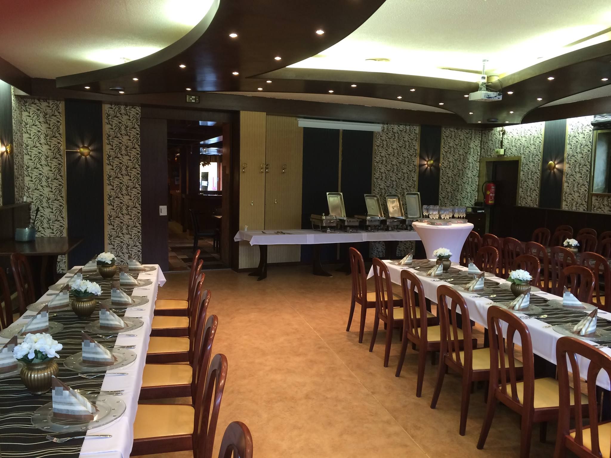 Elegant dining room with laid tables and chairs.