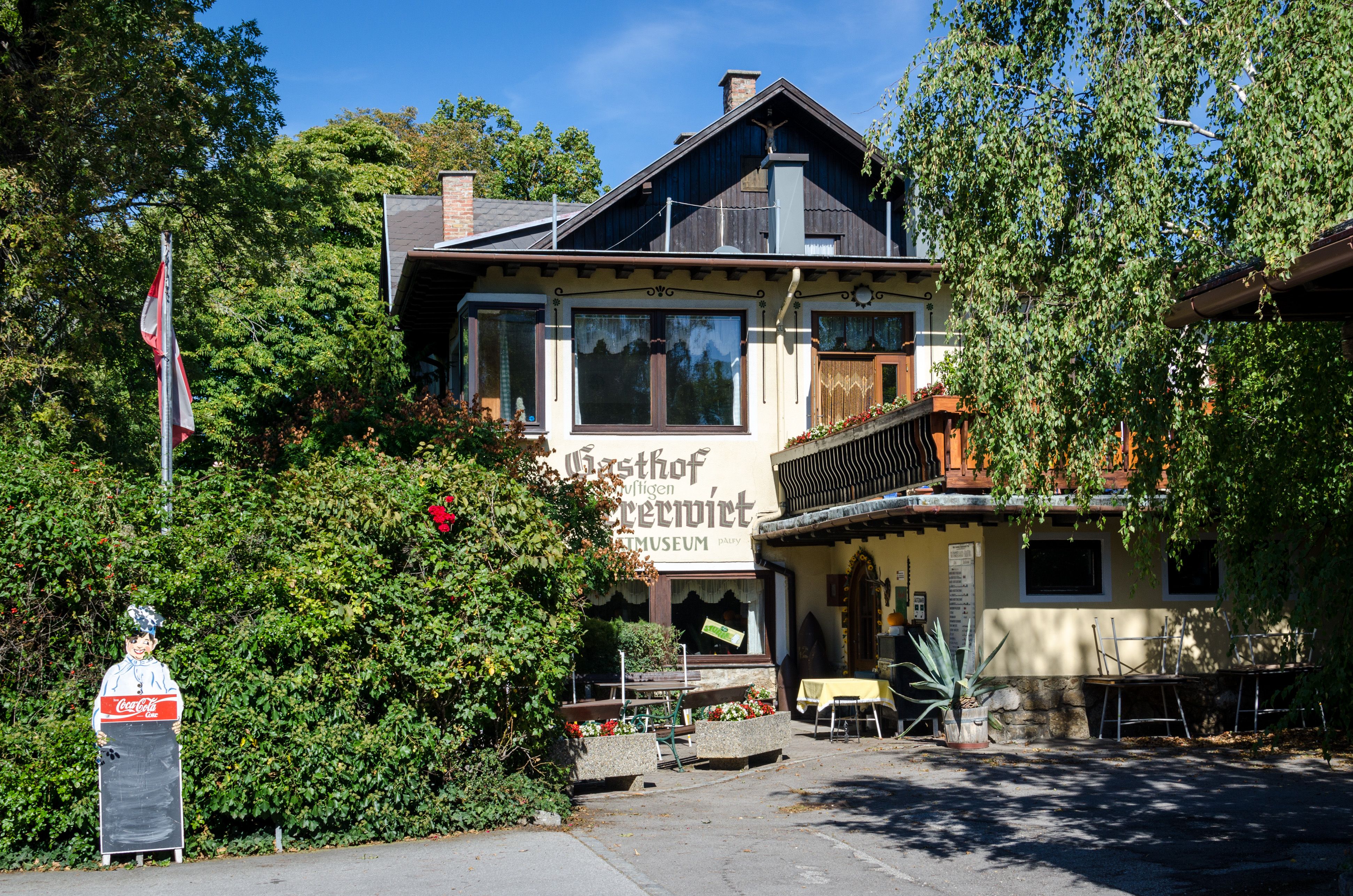 Gasthof Scherrerwirt with terrace and green surroundings.