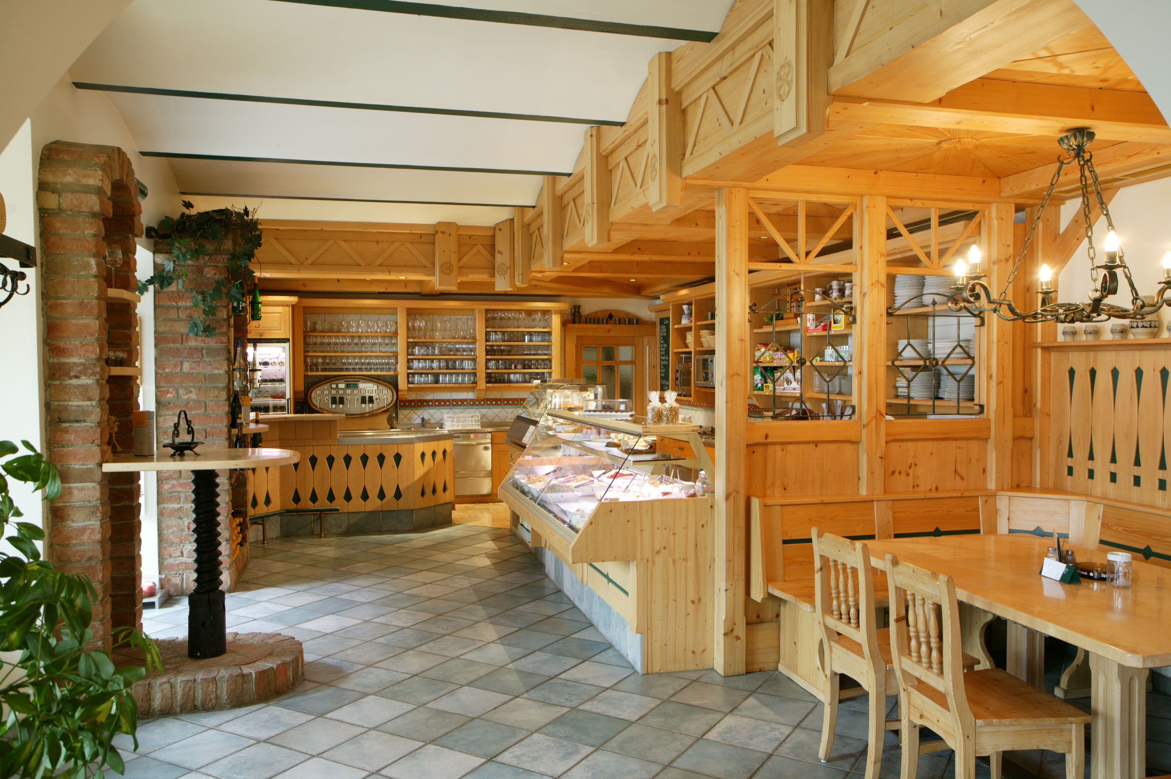 Interior view of a traditional wine tavern with wooden furniture and bar.