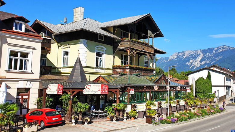 A café with a terrace and mountain views in a picturesque setting.