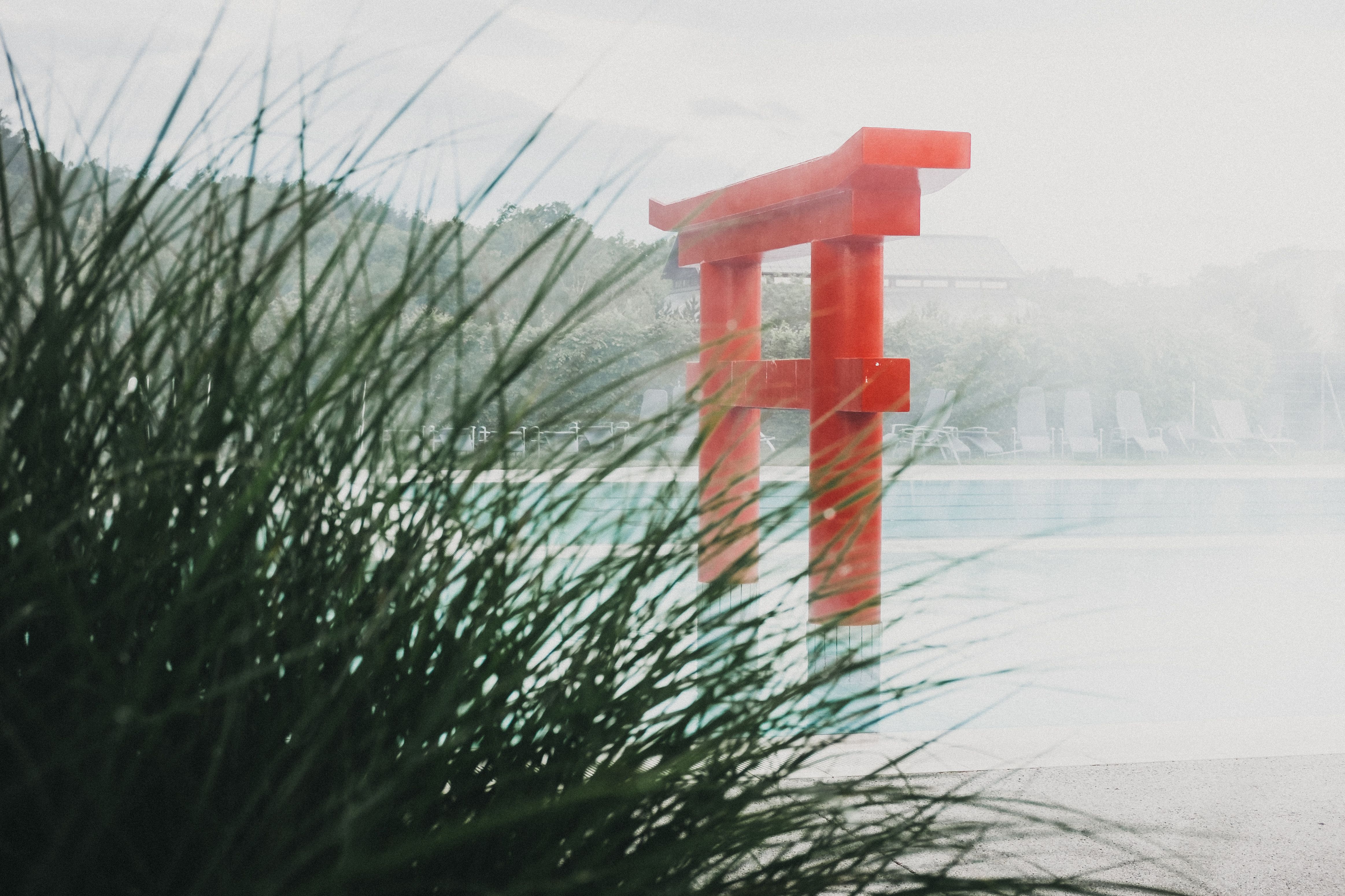 Exterior view of the Linsberg Asia Therme with pool and red torii.