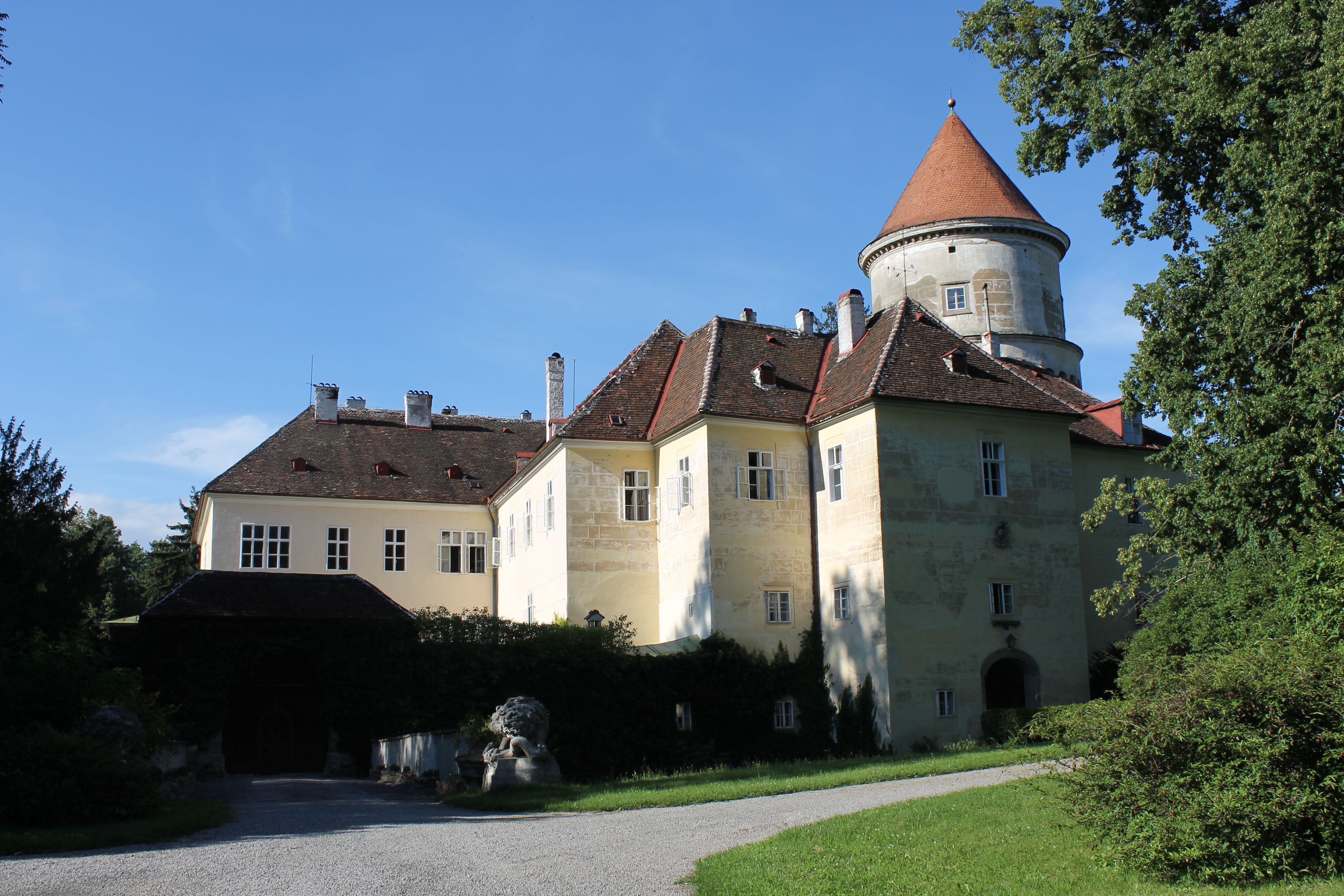 Castle in Pyhra with tower and garden in sunny weather.