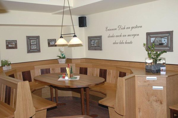 Cozy dining room with wooden furniture and decoration.