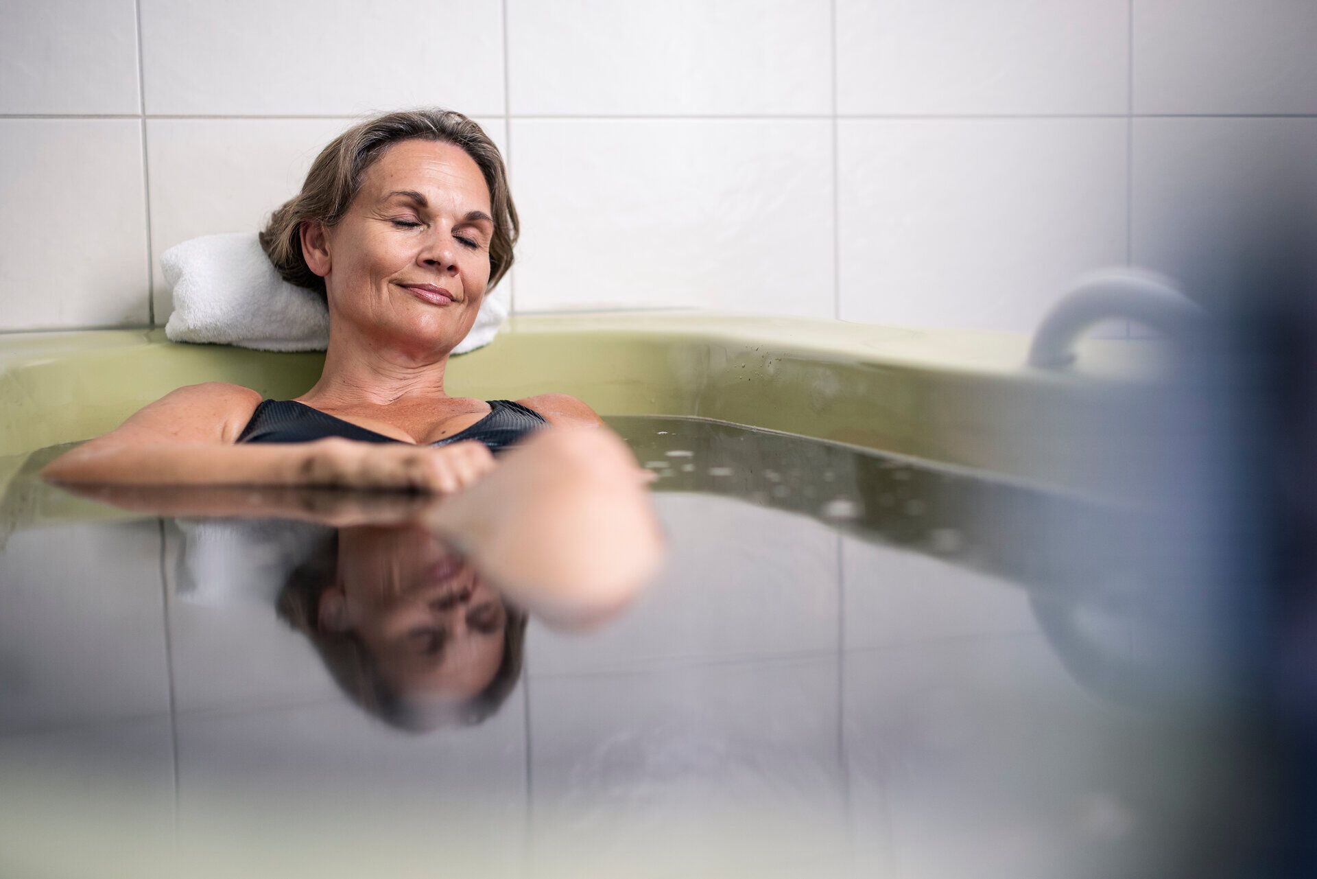 A woman relaxes during a mud treatment at the Bad Großpertholz mud bath in the Waldviertel region.
