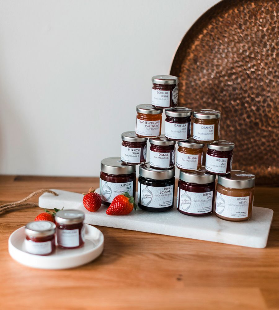 Various jam jars arranged on a table.