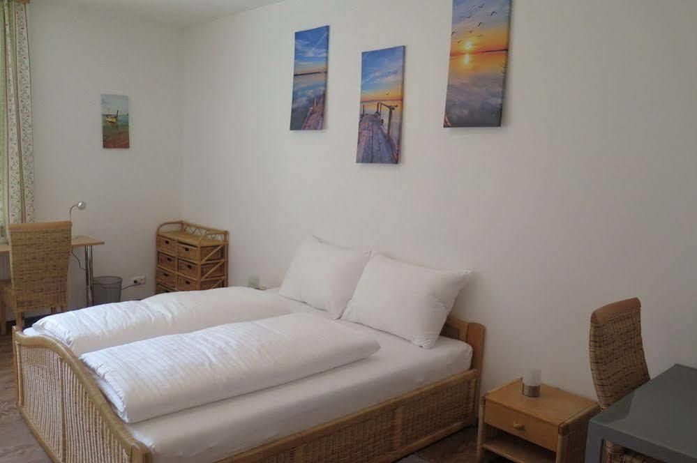 Bright bedroom with double bed, rattan furniture and murals.