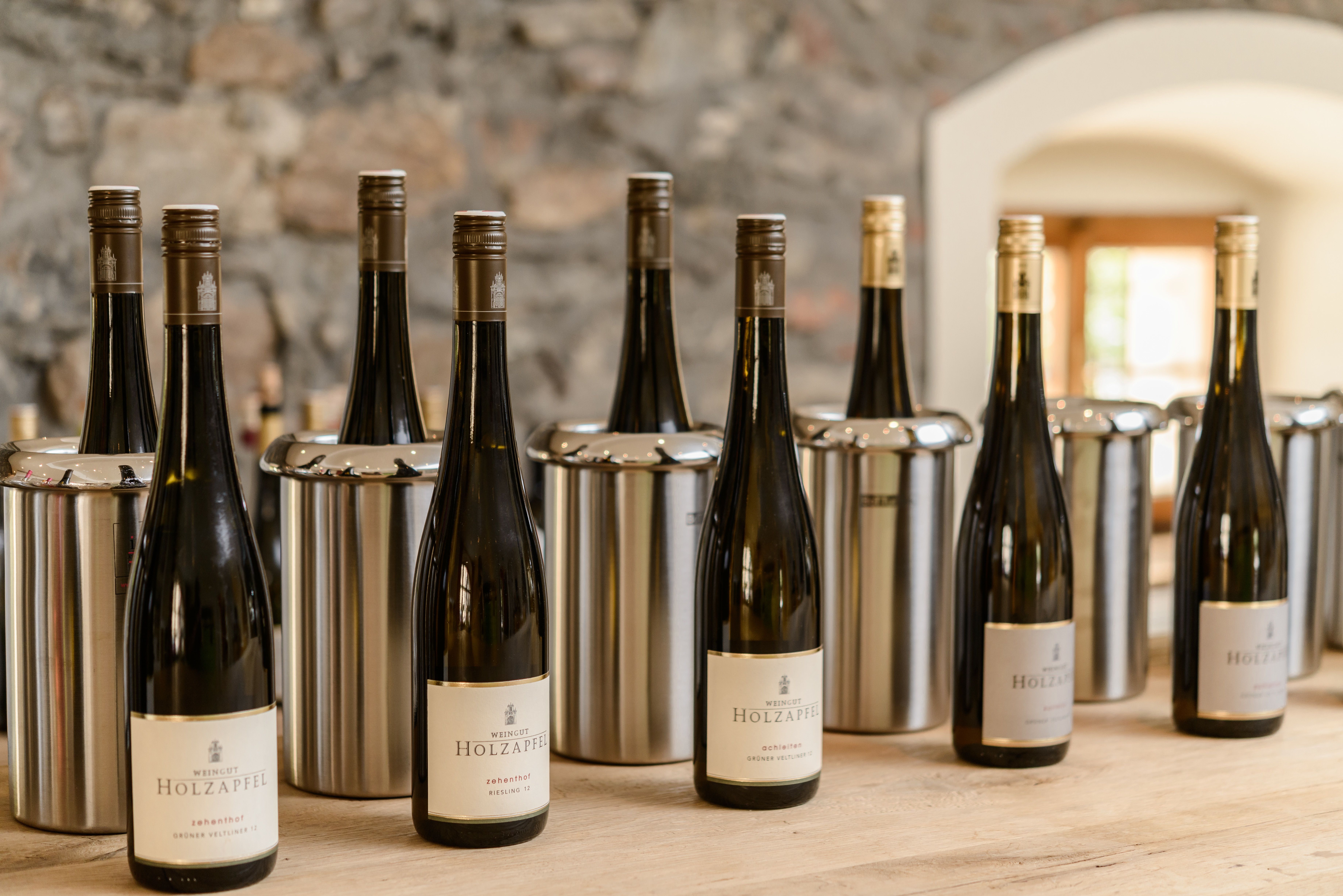 Wine bottles from the Holzapfel winery on a table.