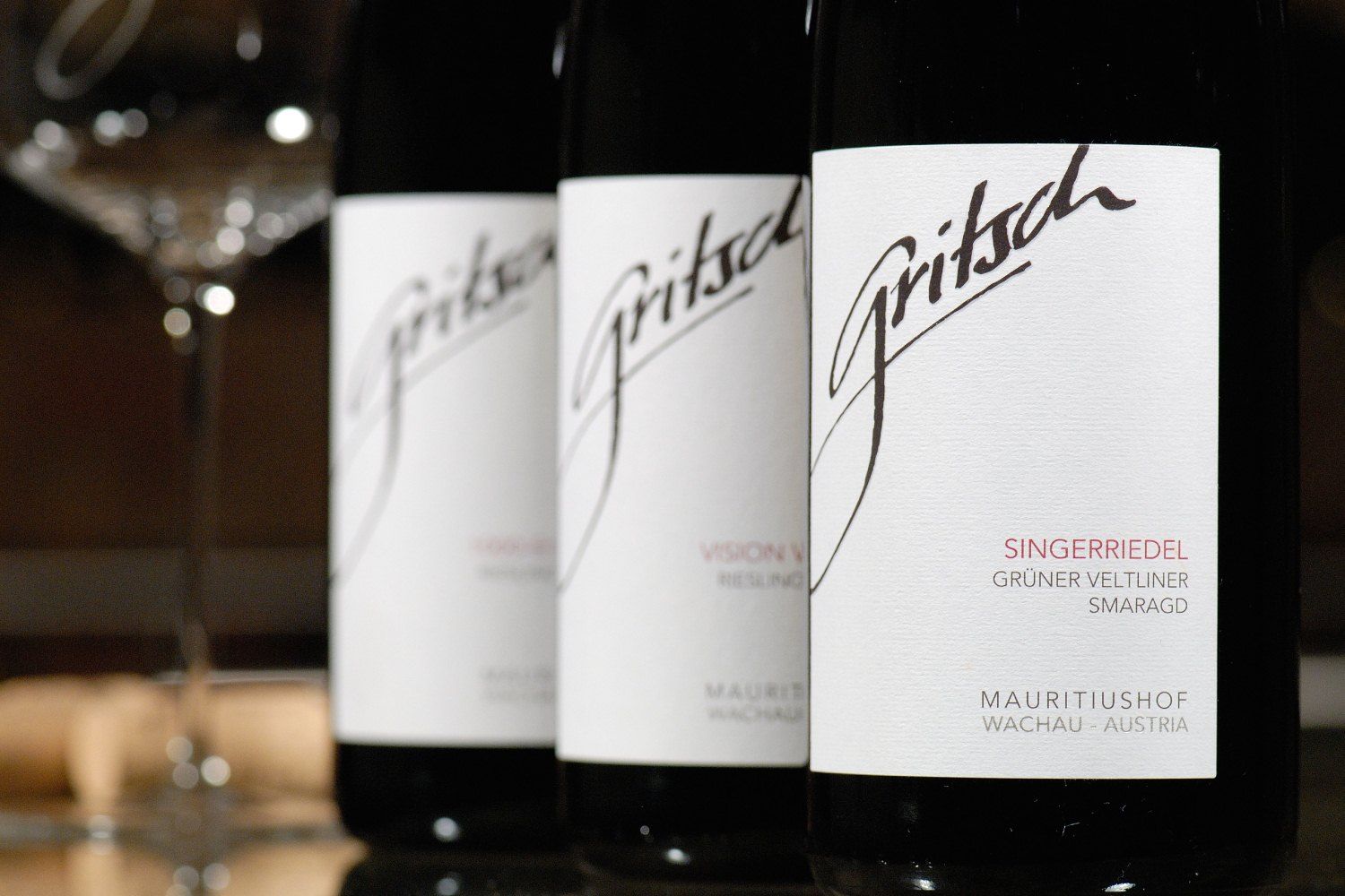 Close-up of three FJ Gritsch wine bottles with labels.