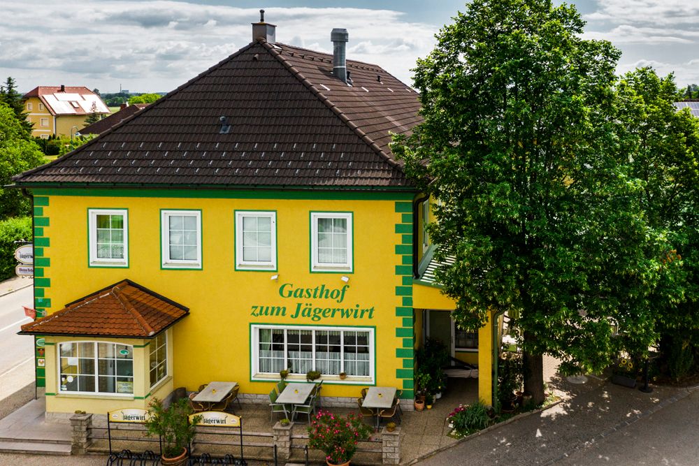 Yellow inn with green accents, "Gasthof zum Jägerwirt".