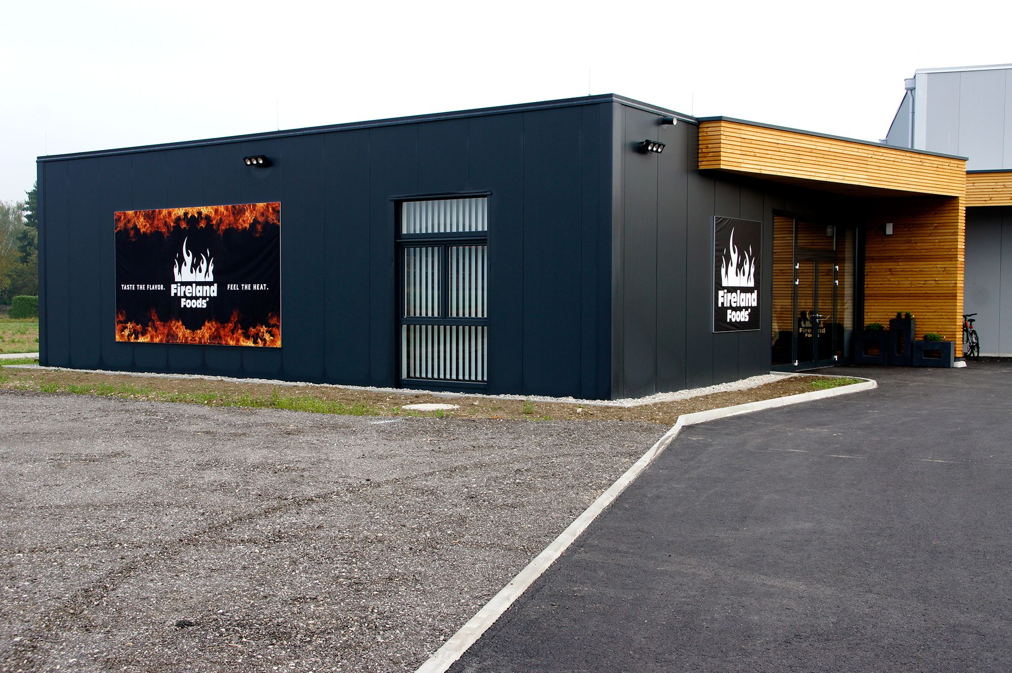 Exterior view of a modern building with Fireland Foods logo and slogan.