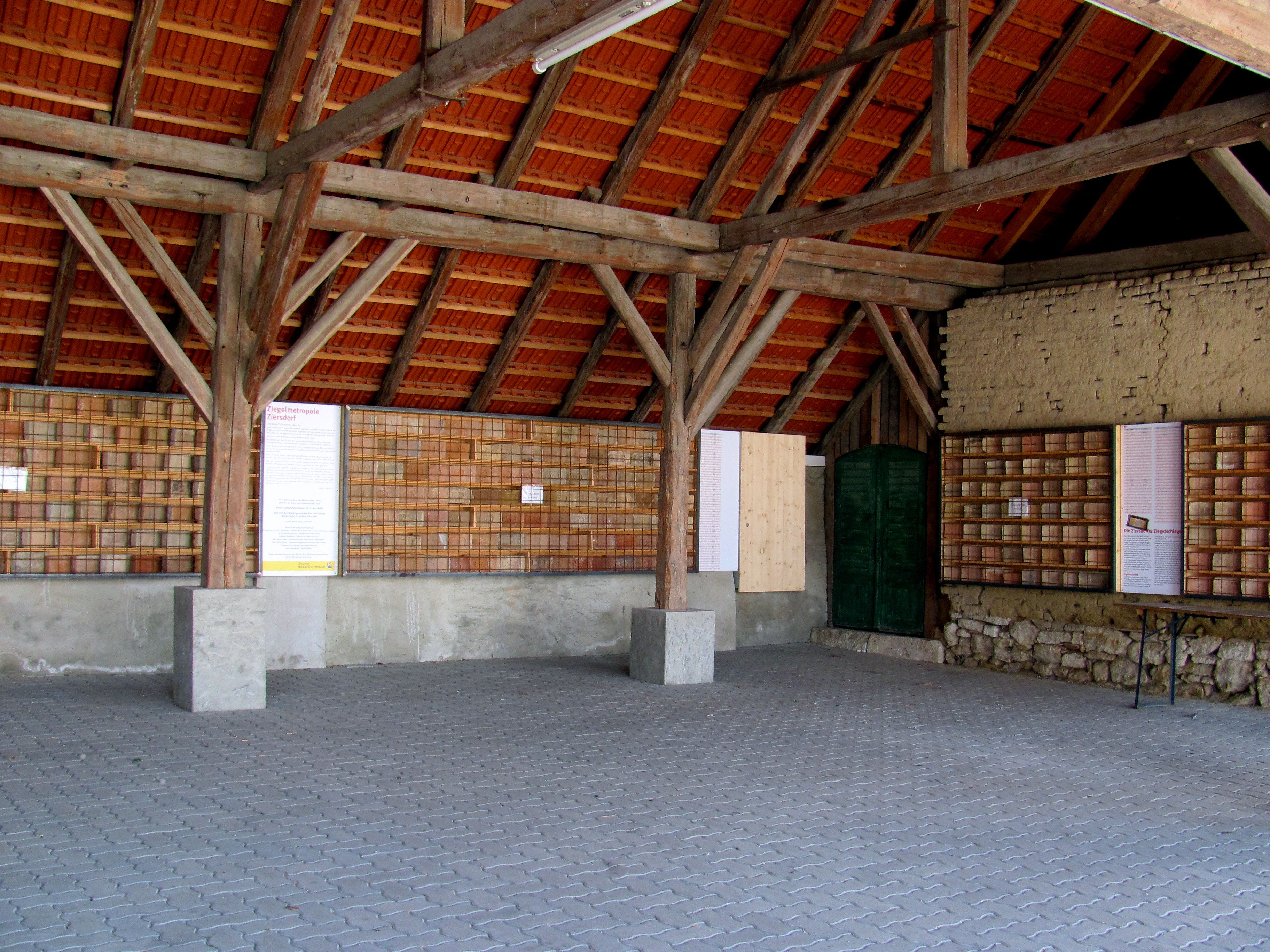 Interior view of the brick museum in Ziersdorf with wooden beams and brick walls.